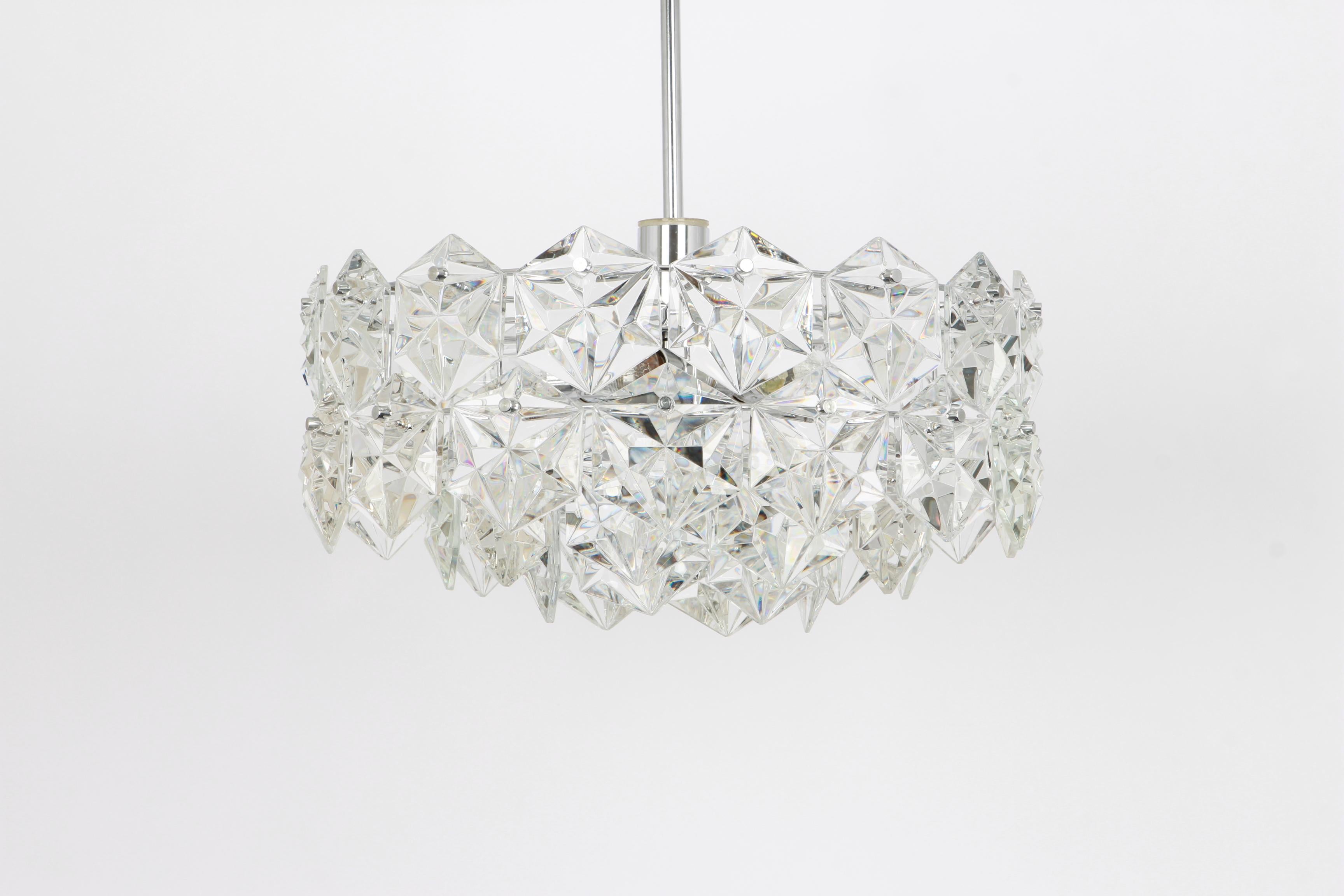 A stunning four-tier chandelier by Kinkeldey, Germany, manufactured in circa 1970-1979. A handmade and high quality piece. The chandelier features a chrome four-tier structure with lots of facetted crystal glass elements.

High quality and in very