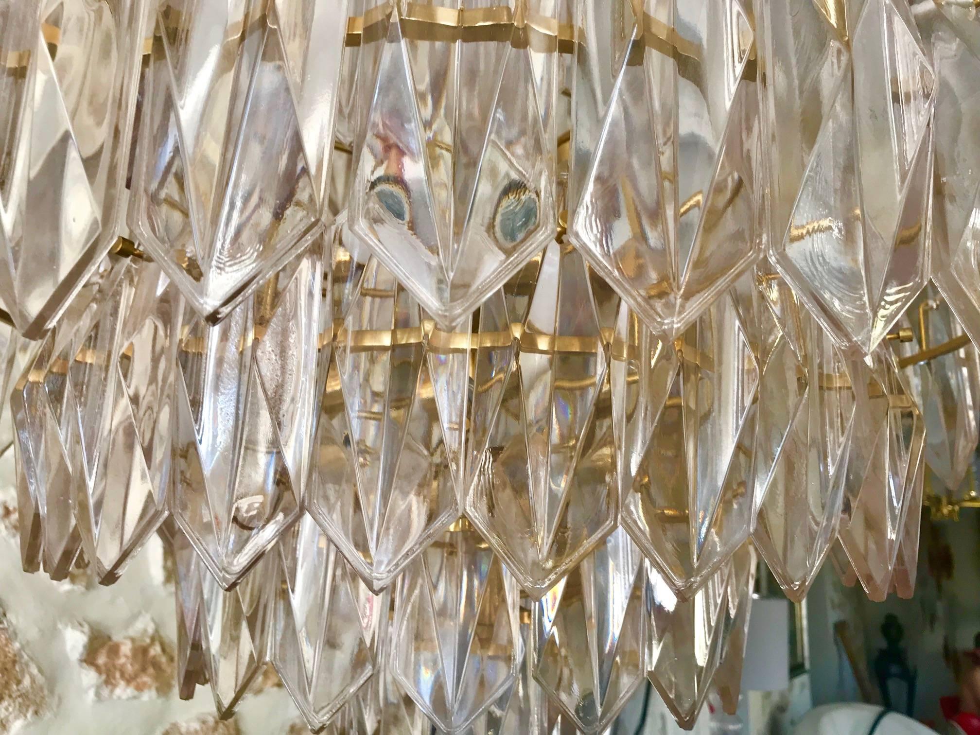 A unique stunning chandelier by Kinkeldey, Germany, manufactured circa 1960-1969. A handmade and high quality piece bi color. The chandelier features a gilt structure from which quality multifaceted crystals are suspended. Eight lights.