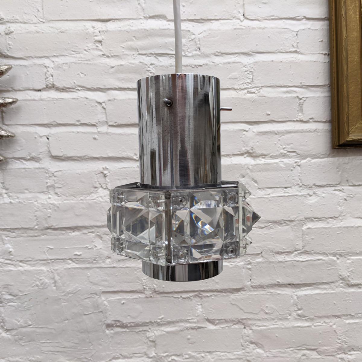 A pair of small pendants composed of six faceted crystal elements and a single socket.
Professionally restored and rewired with new canopy.
Vintage condition with a few tiny chips to some elements and some oxidation to the metal hardware. 
Height