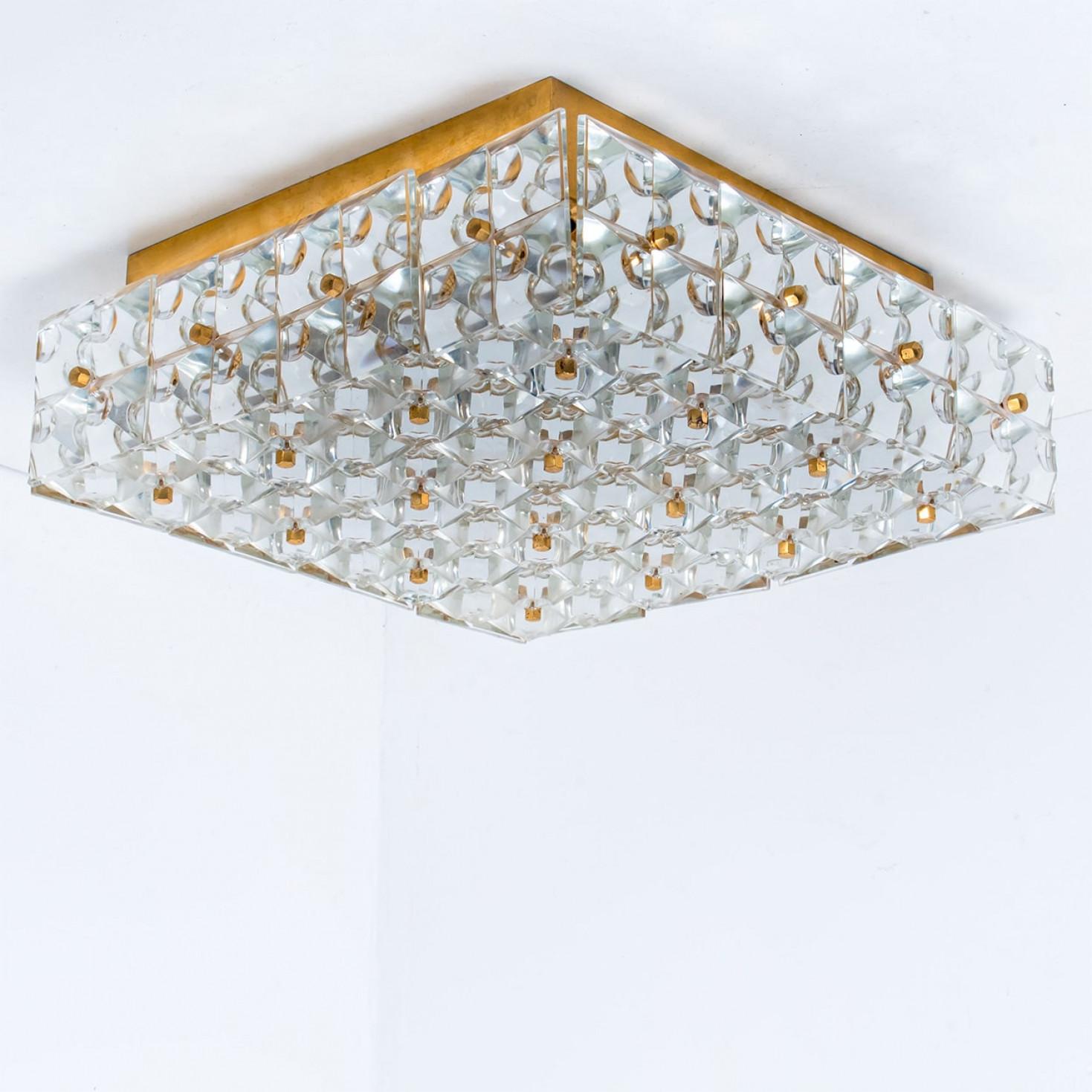 This modernist design flush mount was designed by the Kinkeldey design team during the 1970s, and manufactured in Germany. A handmade and high quality piece.

The crystals are meticulously cut in such a way that the radiate the light of the bulbs in