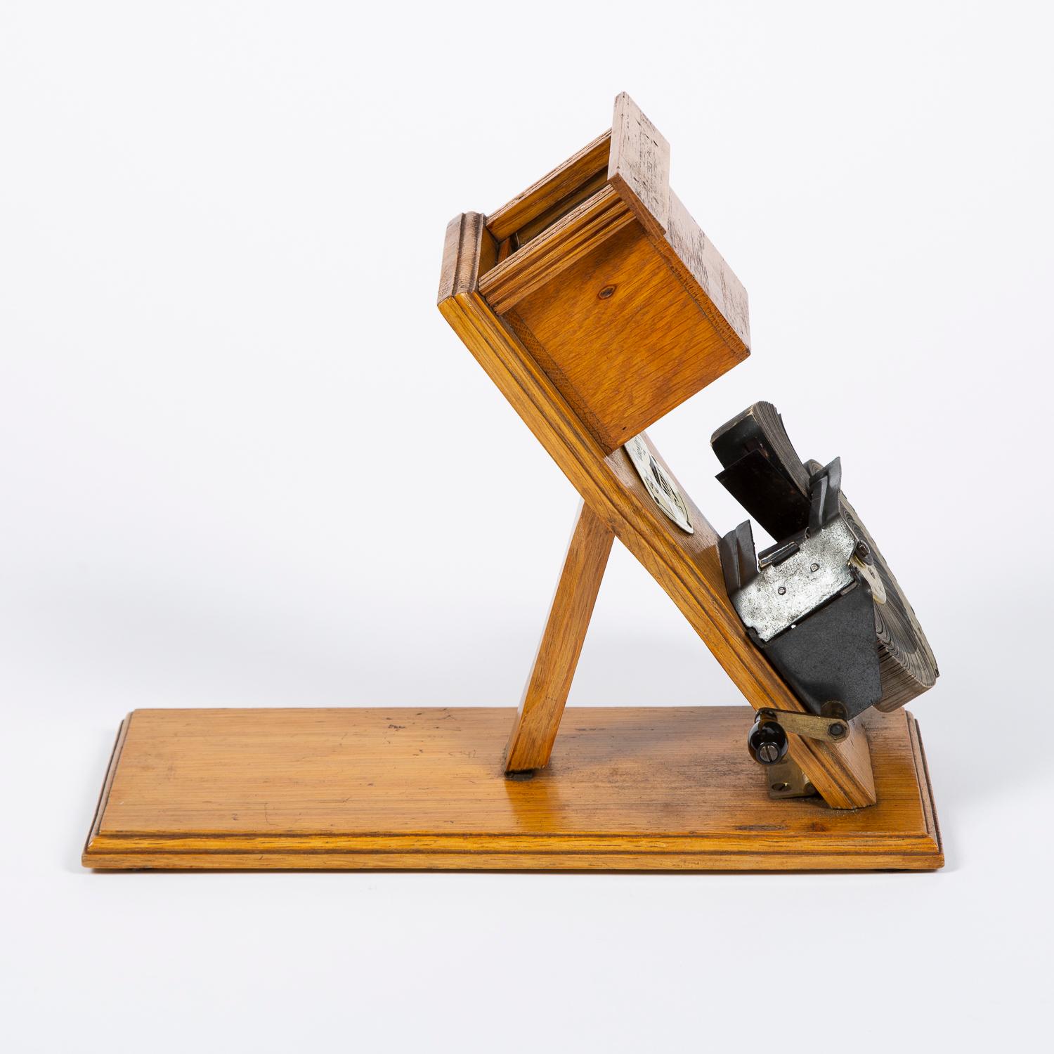 A rare model of a Kinora monochrome motion picture viewer on folding base. Light oak lens holder and base, with the circular Kinora badge, circa 1905.

The Kinora was an early motion picture device, developed by the French inventors Auguste and