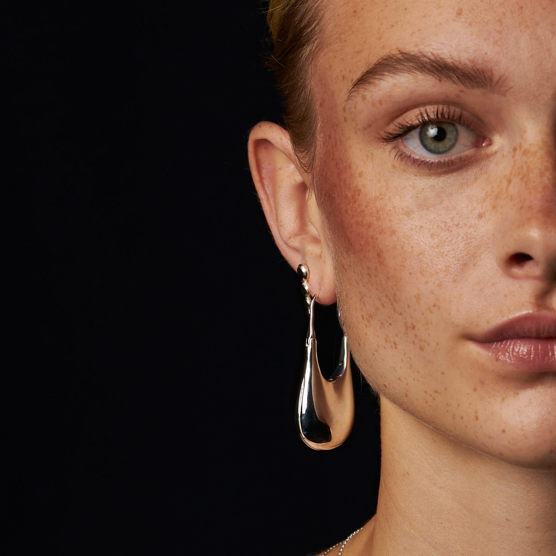 Also available in recycled 18k gold, sterling silver with MPINGO Blackwood, as well as in small size.

Experience the original and iconic light weight drop earring with a gravity-defying look, featuring an intricate hollow corpus developed by