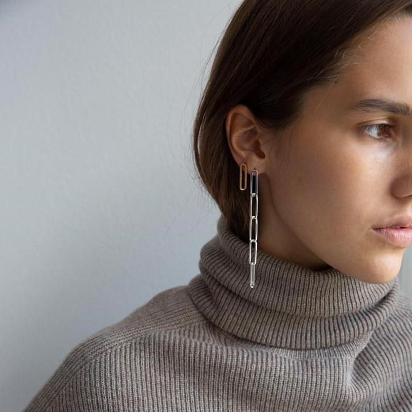 This statement earring with five sleek links is handmade in solid recycled sterling silver. The links are designed according to the ancient art of Japanese wood joinery – they fit neatly together when still, but come softly alive in