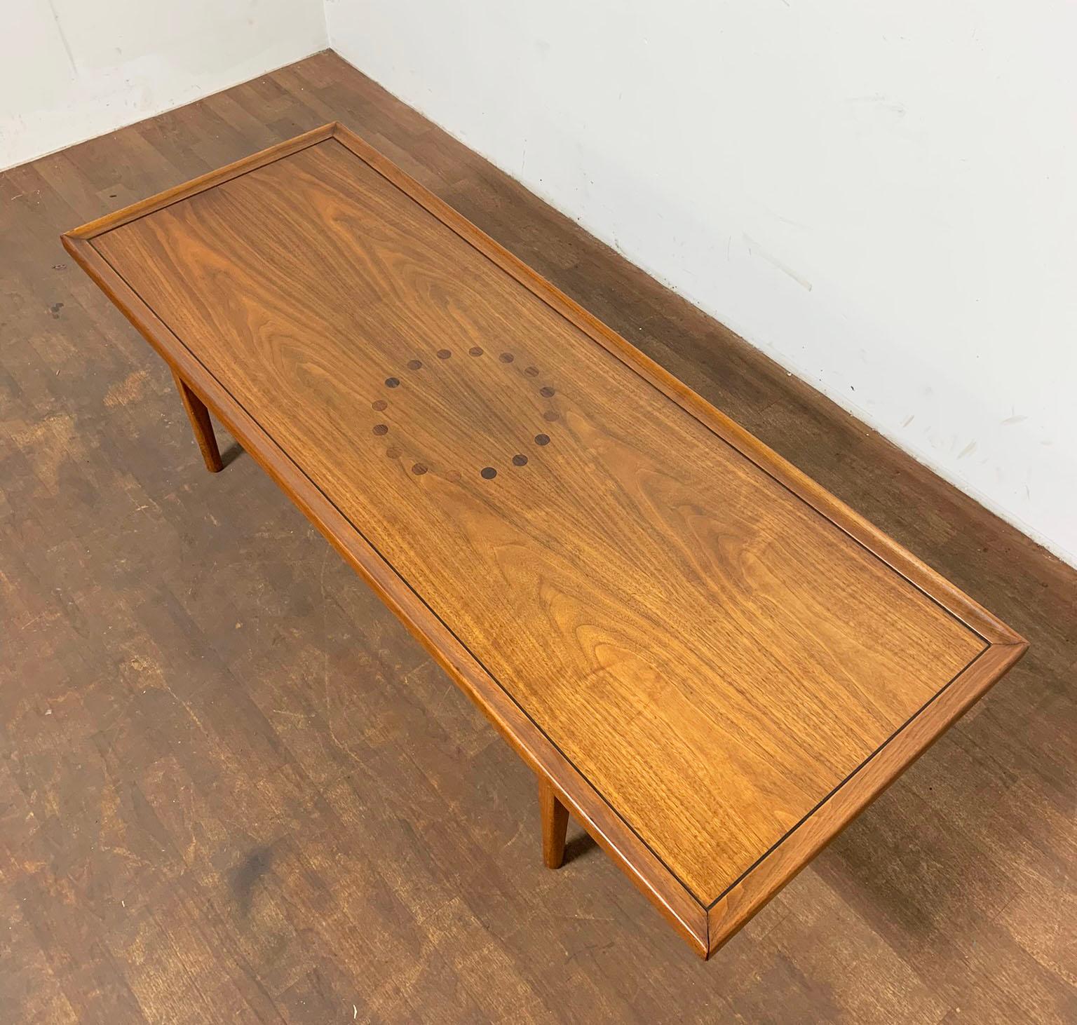 A walnut coffee table with contrasting teak inlay designed by Stewart MacDougall & Kipp Stewart for their Declaration Line for Drexel, circa 1950s.

