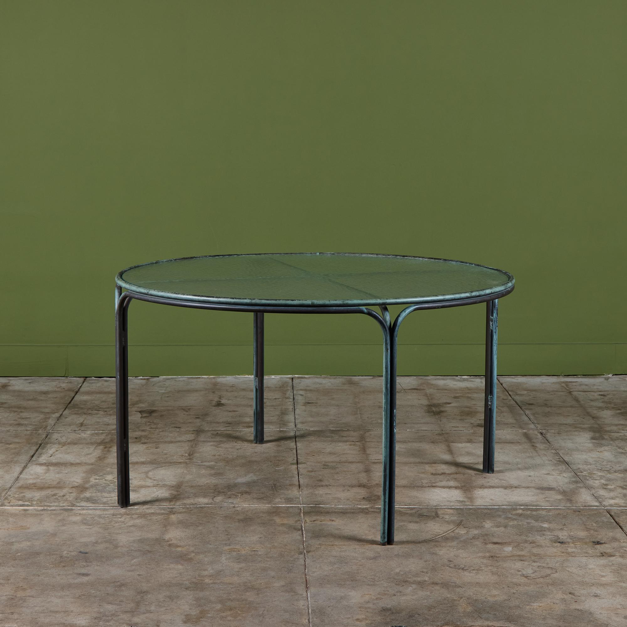 Patio dining table by Kipp Stewart for Terra of California, USA, c.1970s. The table features a bronze tube frame with original pebble glass top.
 
Dimensions
48.5” diameter x 27.25” height
 
Condition
Good vintage condition with age appropriate