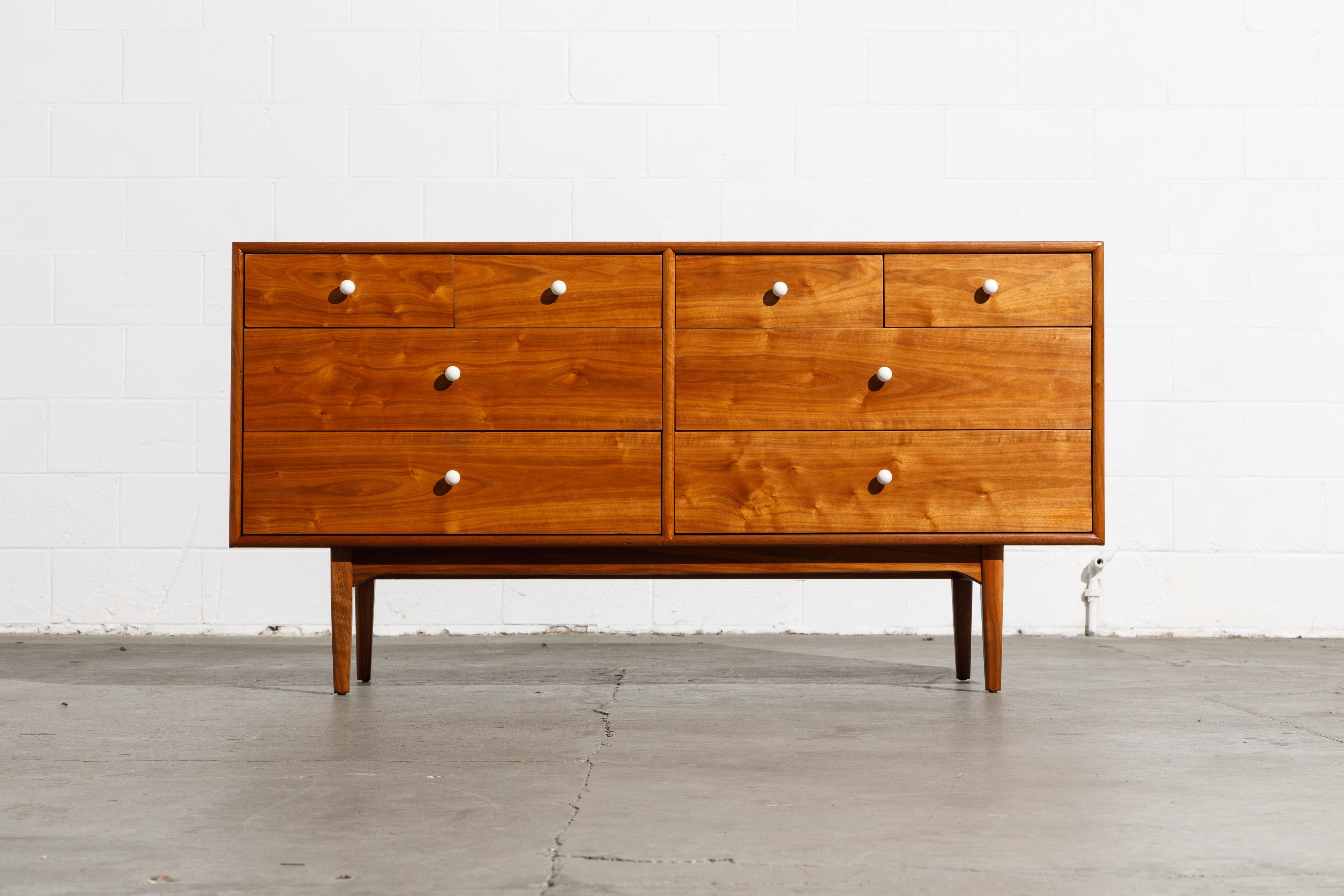 Exceptional Mid-Century Modern eight-drawer dresser and mirror, designed by Kipp Stewart and Stewart McDougall as part of the 'Declaration' line for Drexel furniture. Fabricated from walnut with striking wood grain and dovetail drawers this