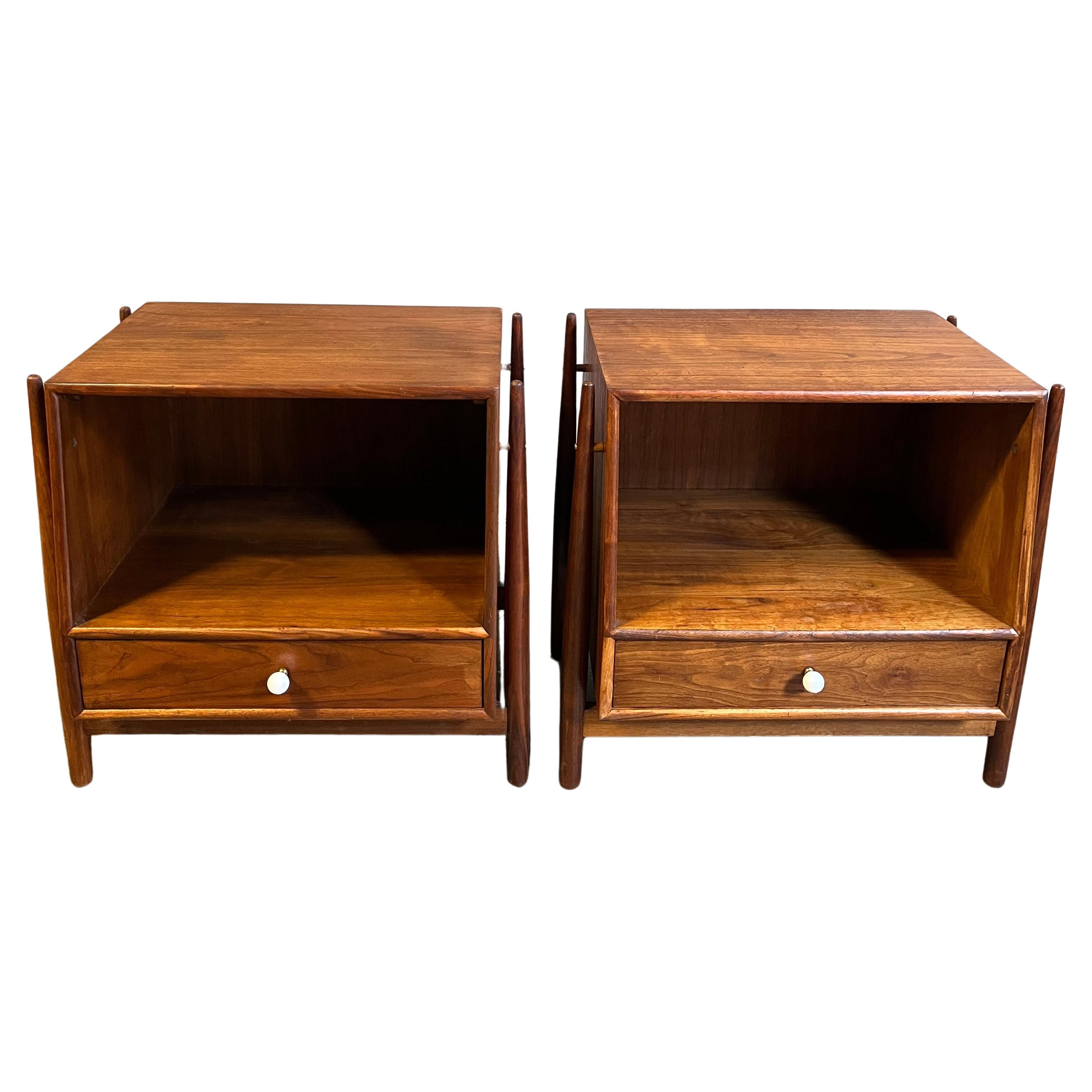 Exceptional pair of refinished 1950's Mid-Century Modern nightstands or can also be used as side or end tables, designed by Kipp Stewart and Stewart McDougall as part of the 'Declaration' line for Drexel furniture. This design being the most coveted