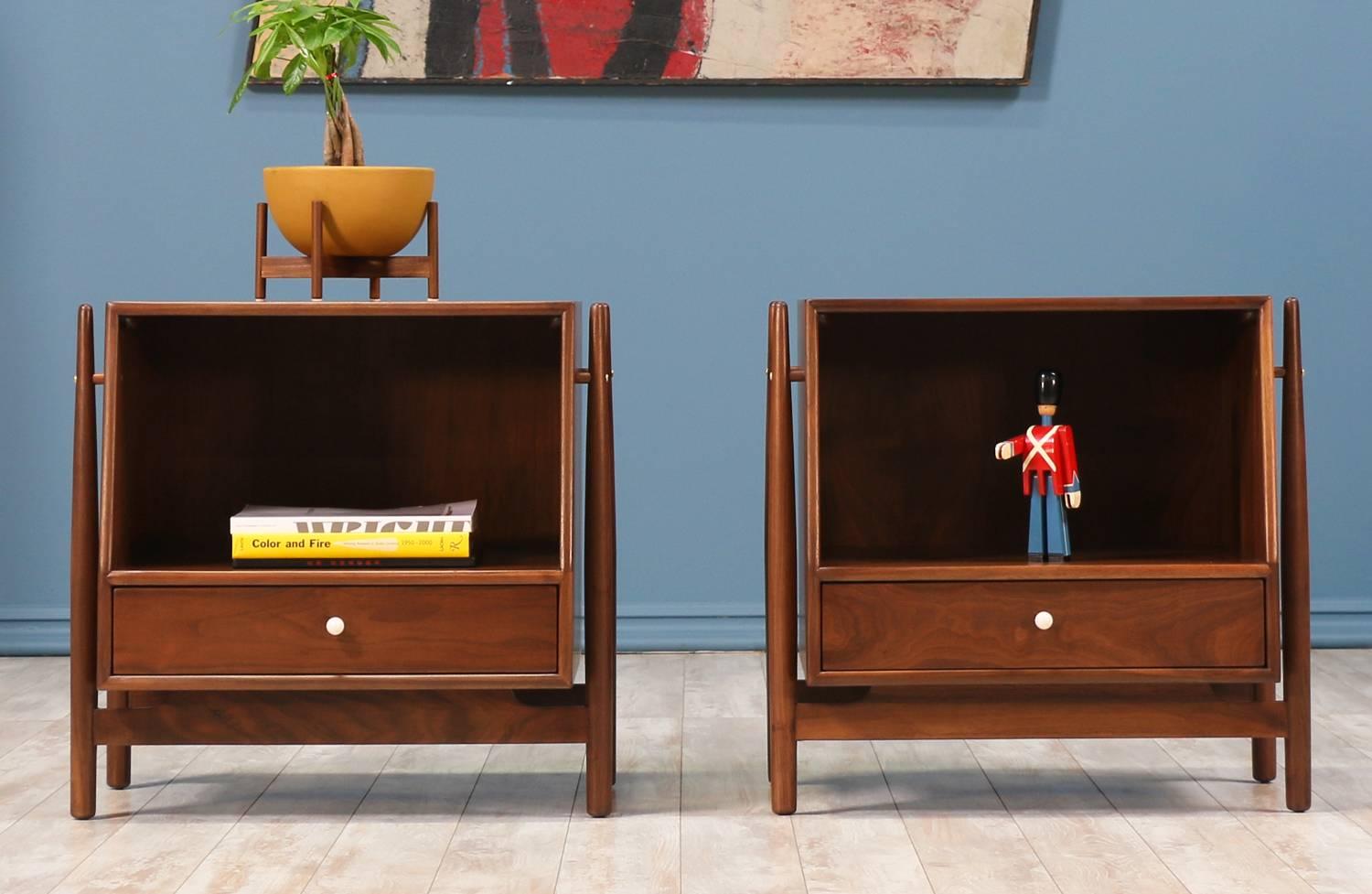 A pair of Night Stands designed by Kipp Stewart & Stewart MacDougall for Drexel in the United States circa 1960’s. These newly restored walnut nightstands feature an open compartment above and a small dovetailed drawer below accented with the