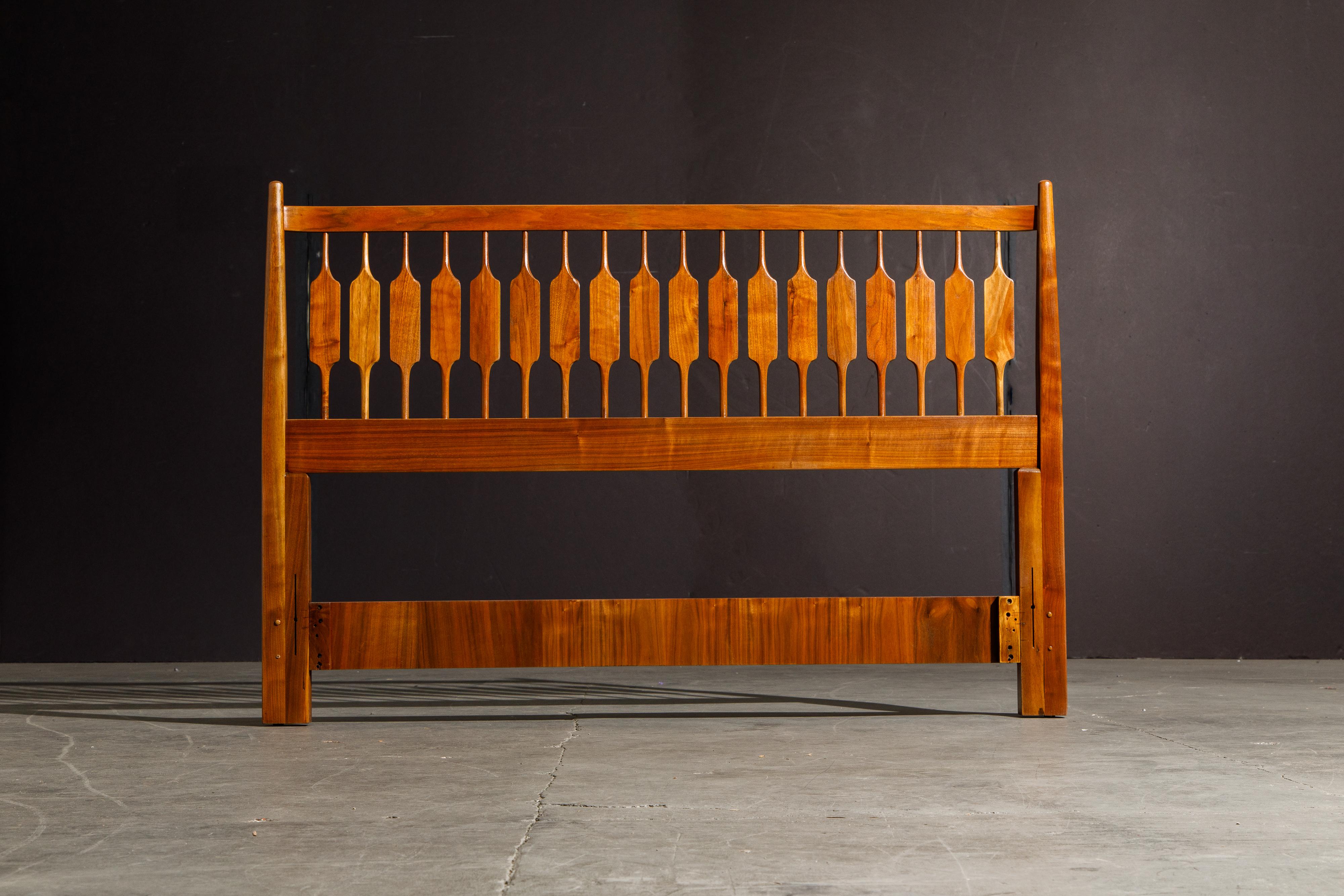 Exceptional Mid-Century Modern headboard for a Queen sized bed, designed by Kipp Stewart and Stewart McDougall as part of the 'Declaration' line for Drexel furniture. Fabricated from walnut with striking wood grain this beautiful headboard has been