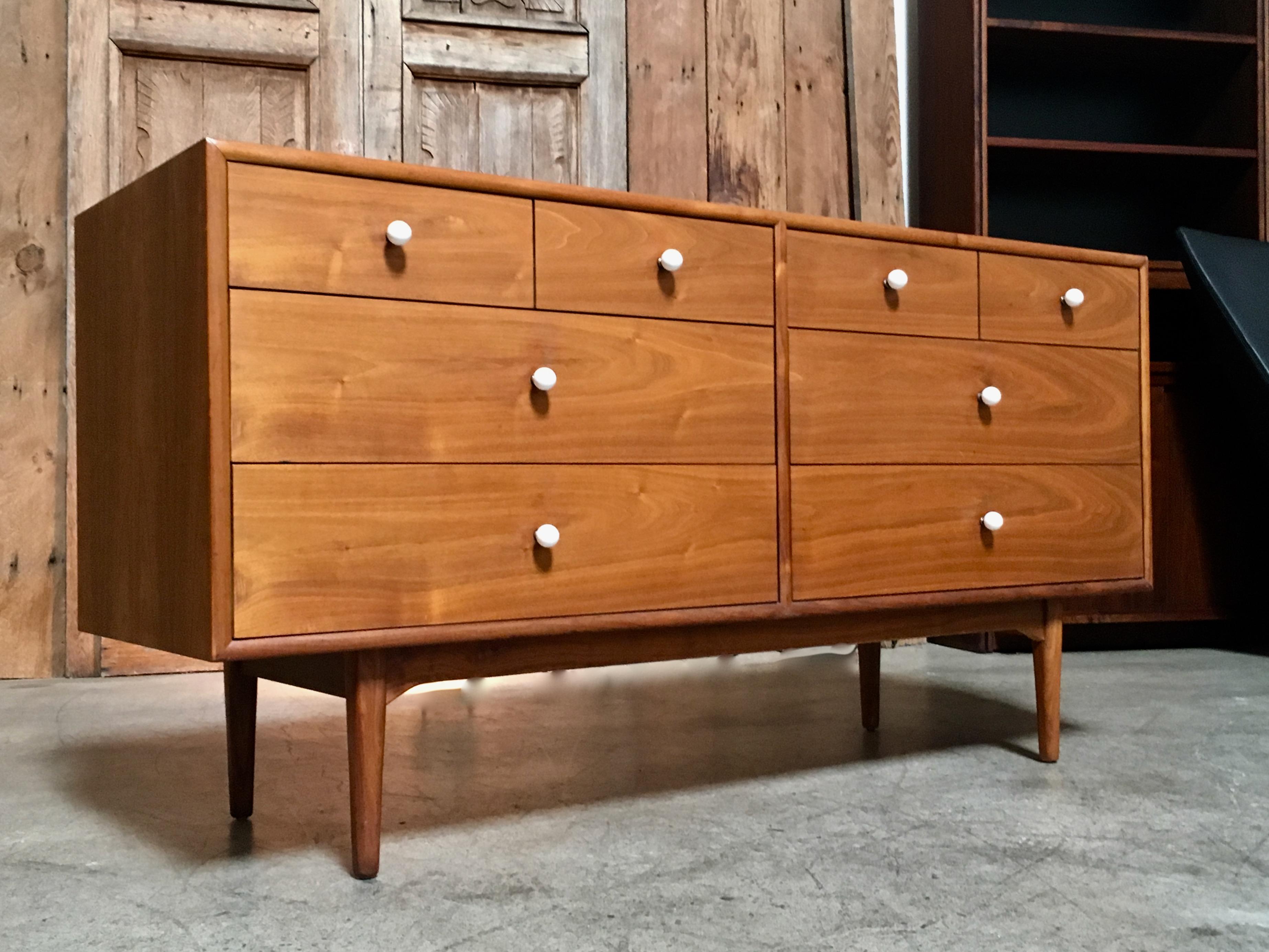 Walnut eight-drawer dresser with four on top over four larger drawers with white pulls
Designed by Kipp Stewart for Drexel.