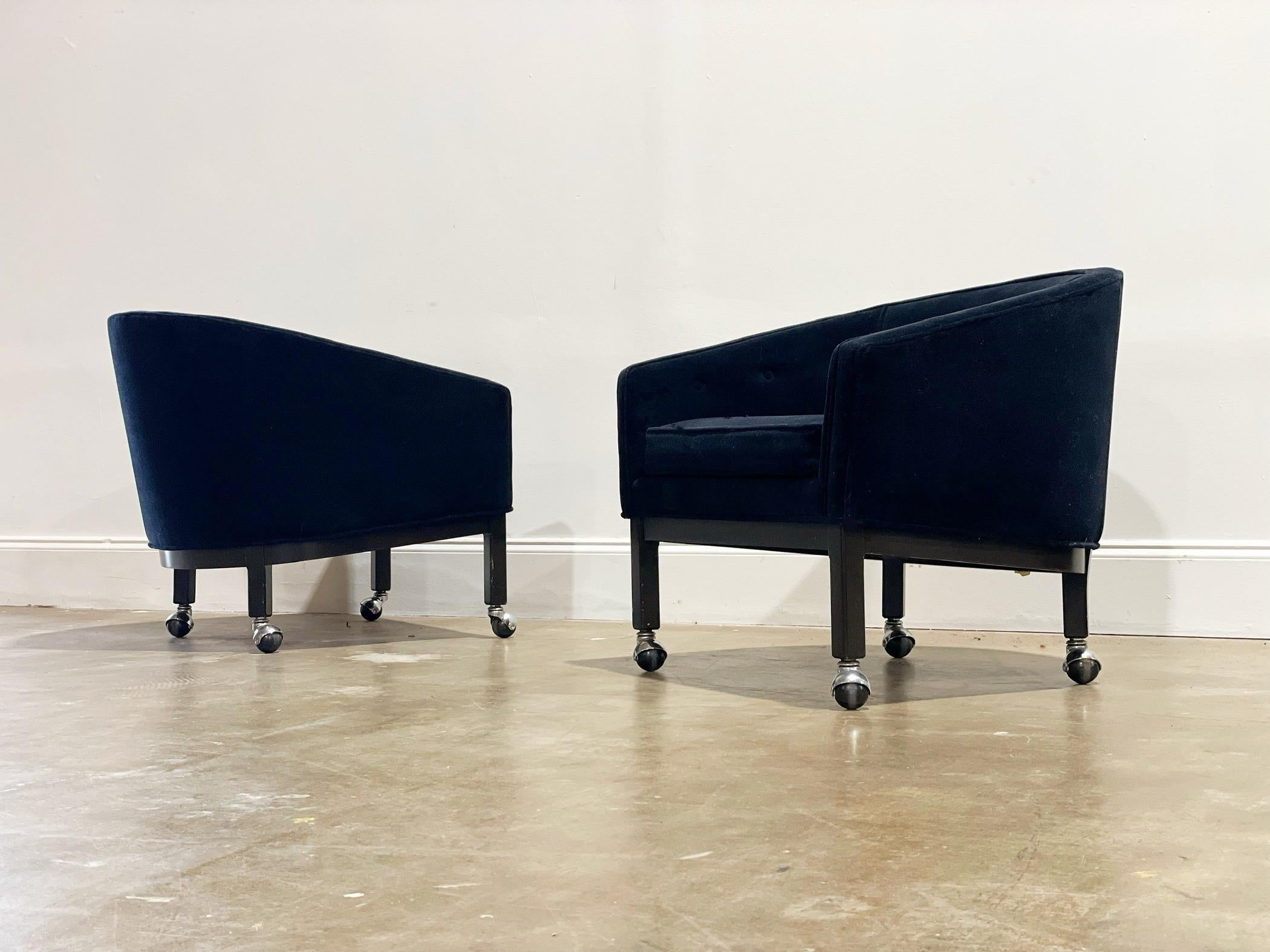 Exceptional barrel back lounge chairs by Kipp Stewart for Directional with all original tufted black velvet. Solid dark mahogany bases with chrome casters. An elegant and modern silhouette lends to a multitude of design esthetics. Attended to by our