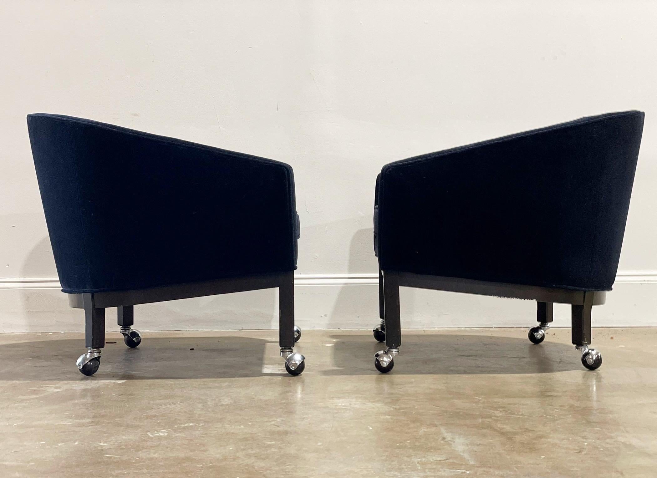 Exceptional barrel back lounge chairs by Kipp Stewart for Directional with all original tufted black velvet. Solid dark mahogany bases with chrome casters. An elegant and modern silhouette lends to a multitude of design esthetics. Attended to by our