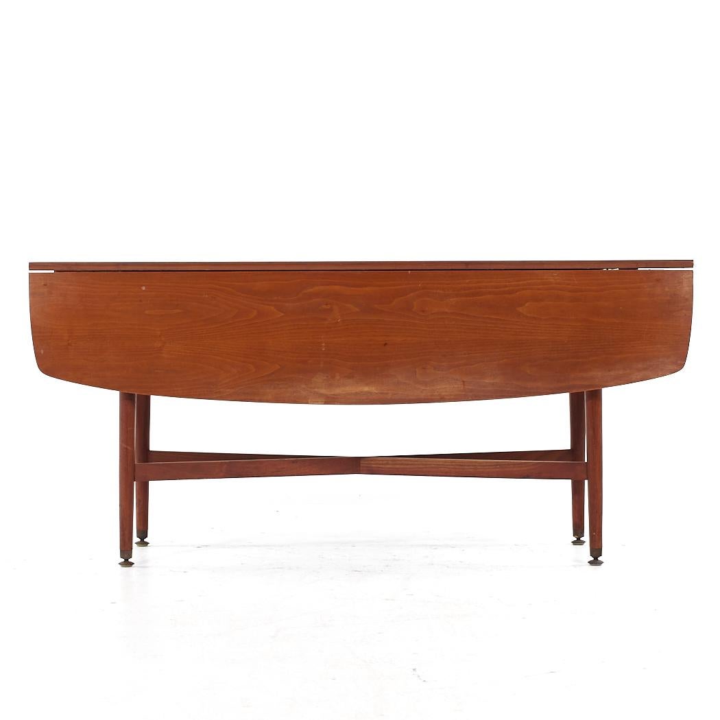 Kipp Stewart for Drexel Declaration Mid Century Walnut Drop Leaf Dining Console Table

This table measures: 60 wide x 17.75 deep x 27.75 inches high, with a chair clearance of 27 inches, when each drop leaf is engaged the depth of the table is 42