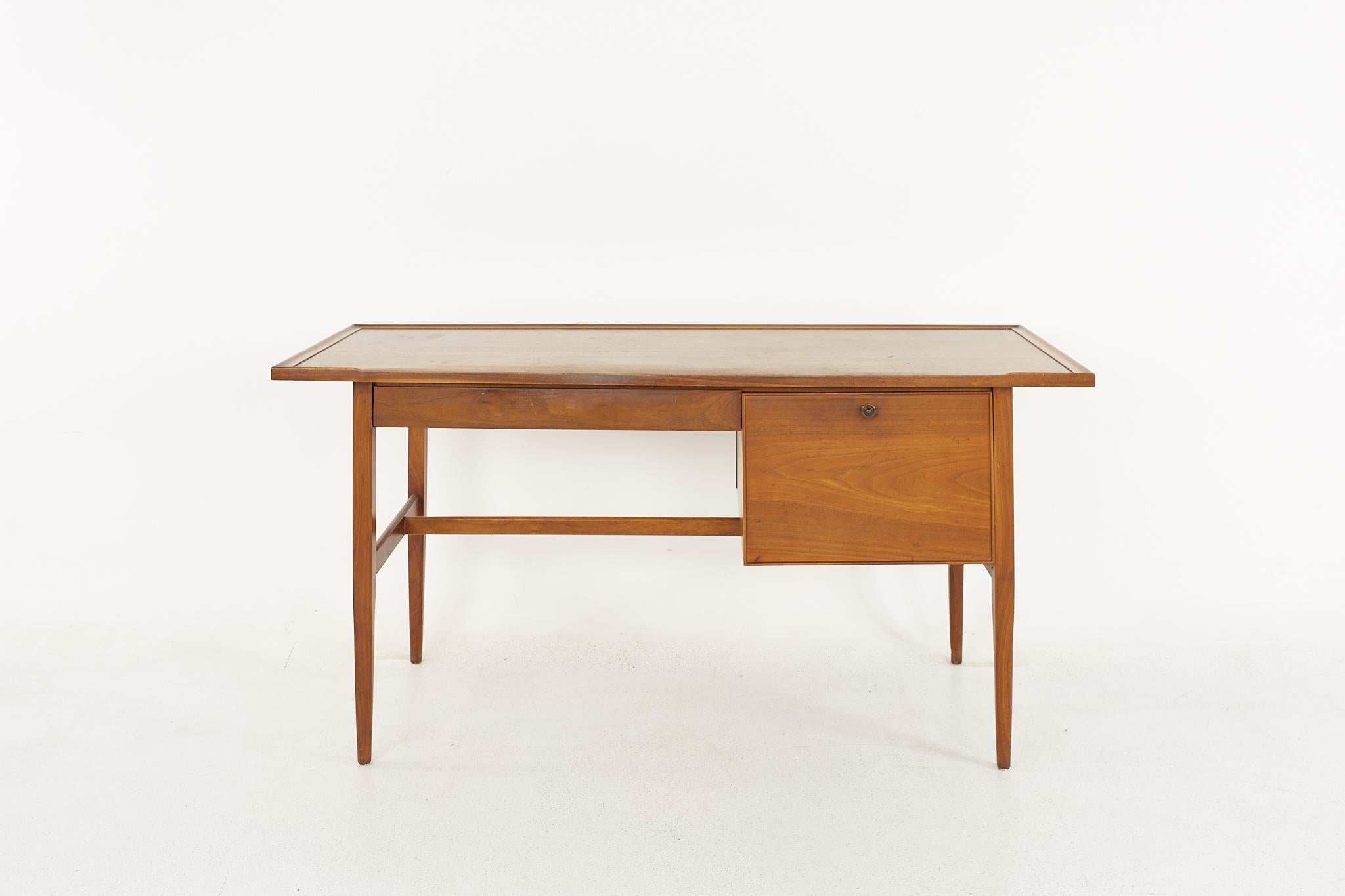 Kipp Stewart for Drexel Declaration mid-century walnut writing desk.

The desk measures: 60 wide x 24 deep x 29.25 high, with a chair clearance of 24.5 inches.

All pieces of furniture can be had in what we call restored vintage condition. That