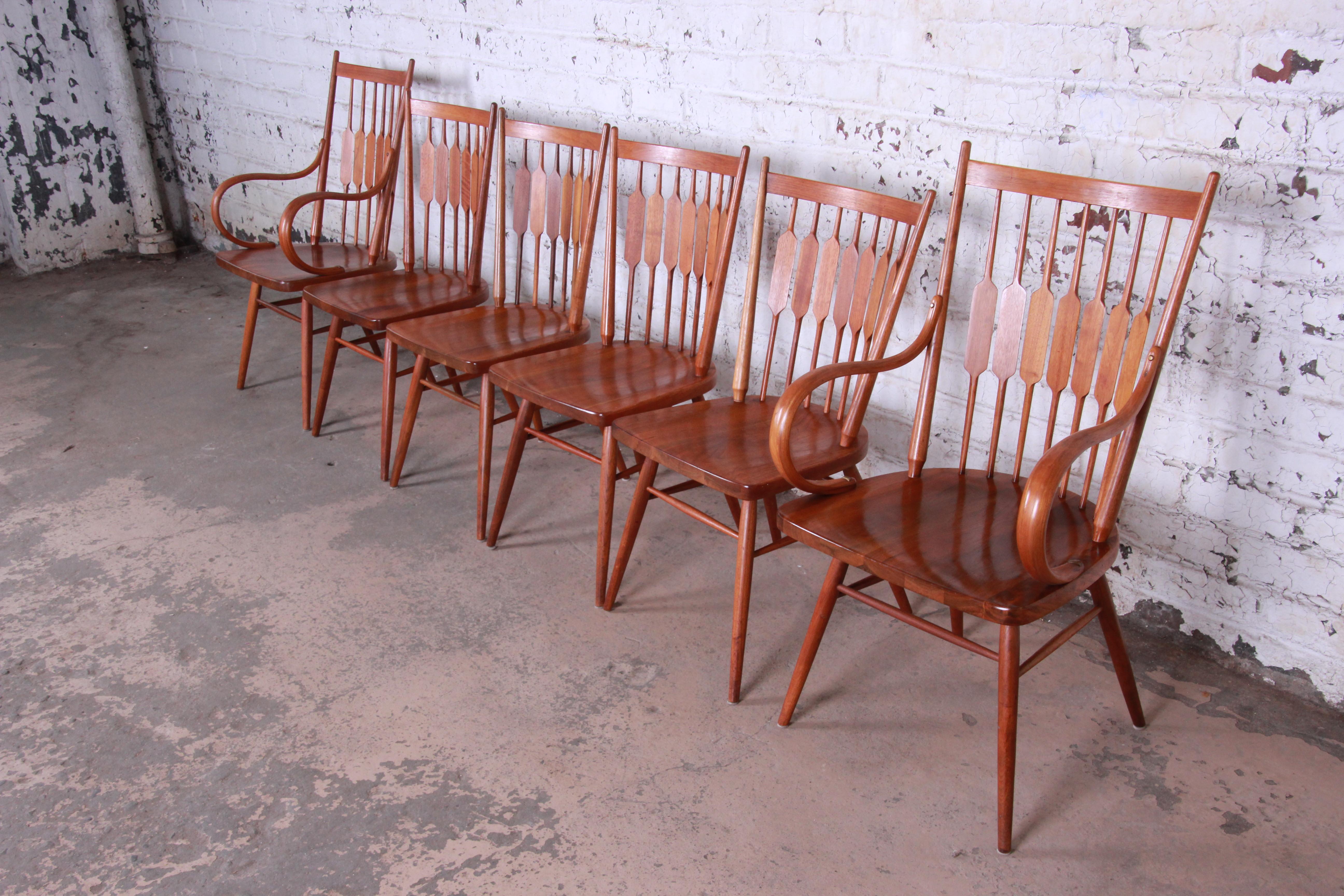 A rare and gorgeous set of six Mid-Century Modern sculpted walnut dining chairs designed by Kipp Stewart for his Declaration line for Drexel. The set includes two captain armchairs and four side chairs. The chairs are a modern take on the Windsor