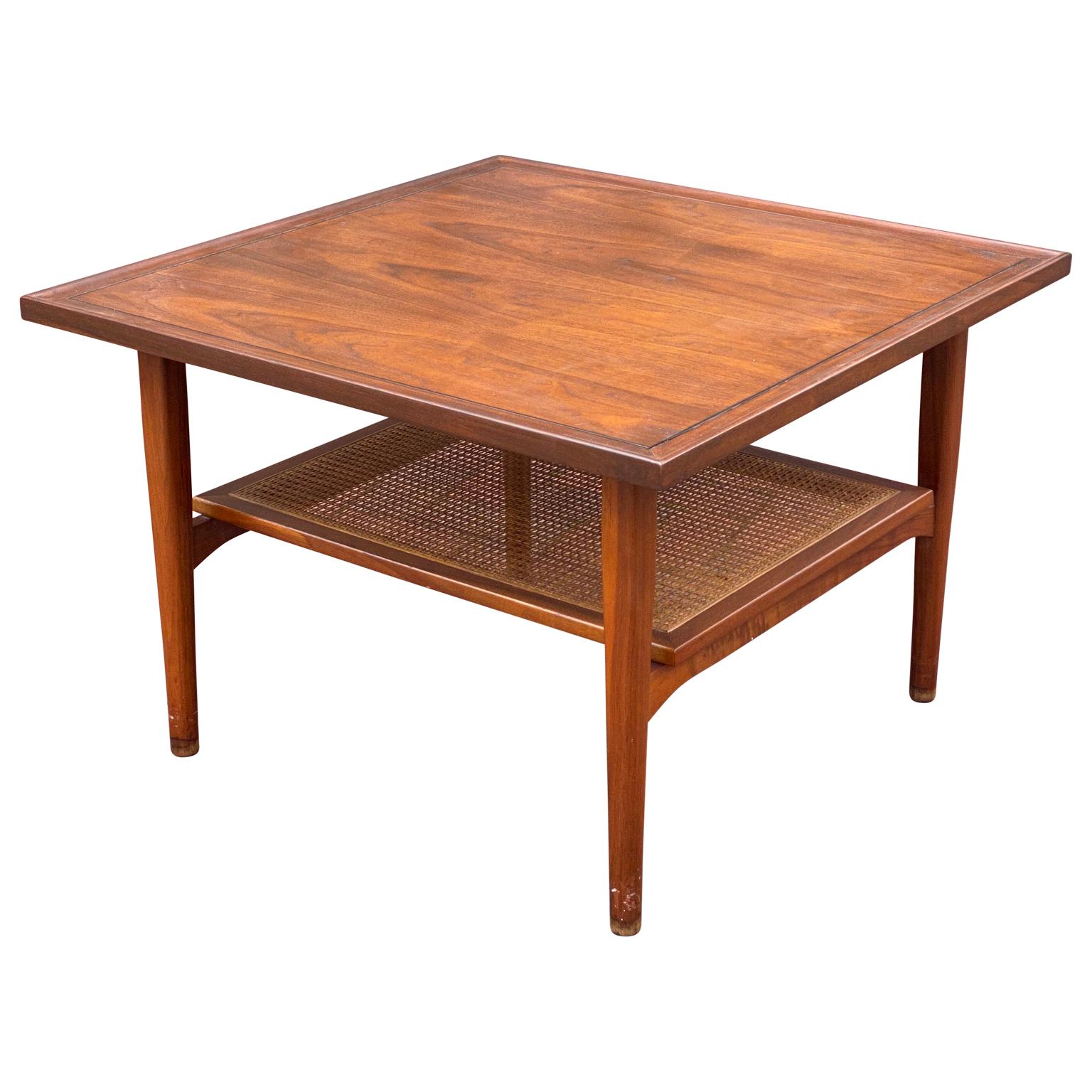 Vintage, Mid-Century Modern walnut and cane two tier coffee table or side table by Kipp Steward for Drexel Declaration. Not easily found, this beautiful square table has been expertly refinished to restore it's original glow. The caned lower shelf
