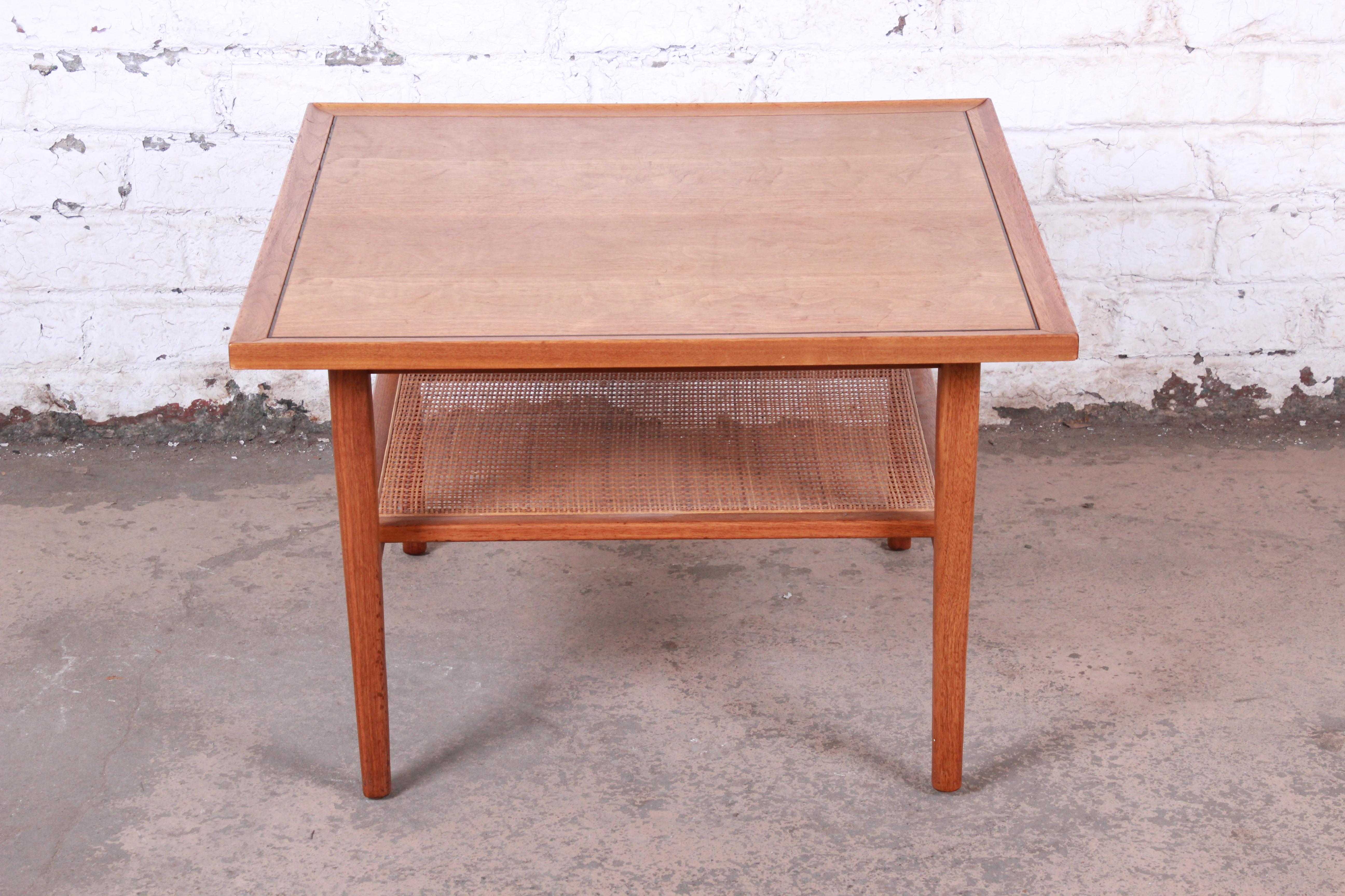 A gorgeous Mid-Century Modern walnut and cane two-tier coffee table or occasional side table

By Kipp Stewart for Drexel Declaration

USA, 1958

Measures: 30