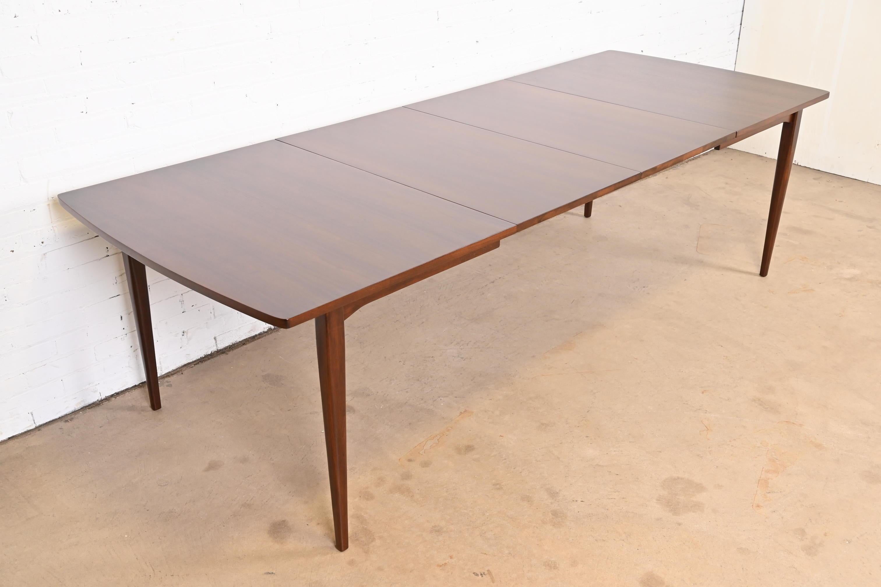 An exceptional Mid-Century Modern walnut extension dining table

By Kipp Stewart for Drexel, 