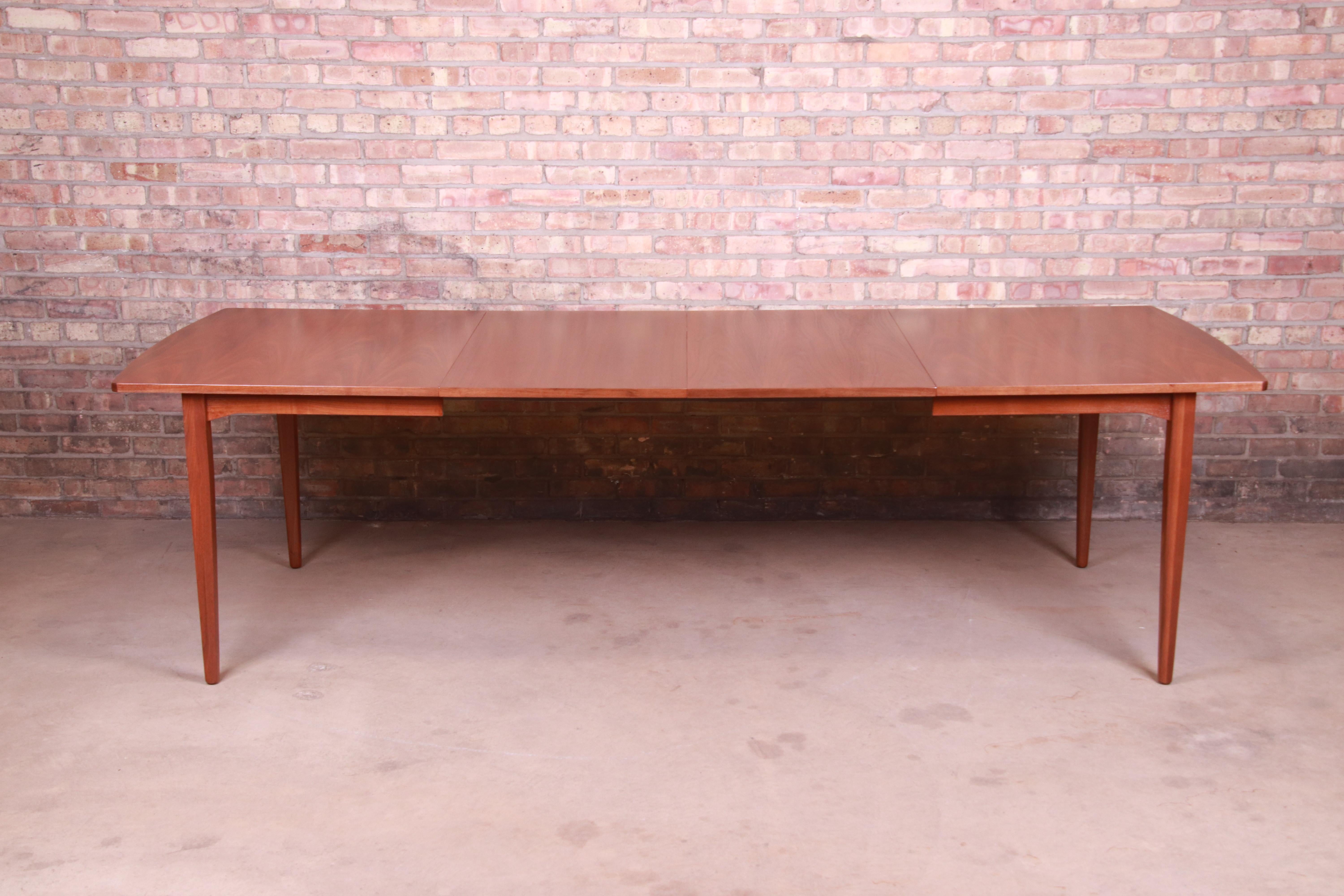 An exceptional Mid-Century Modern walnut extension dining table

By Kipp Stewart for Drexel 