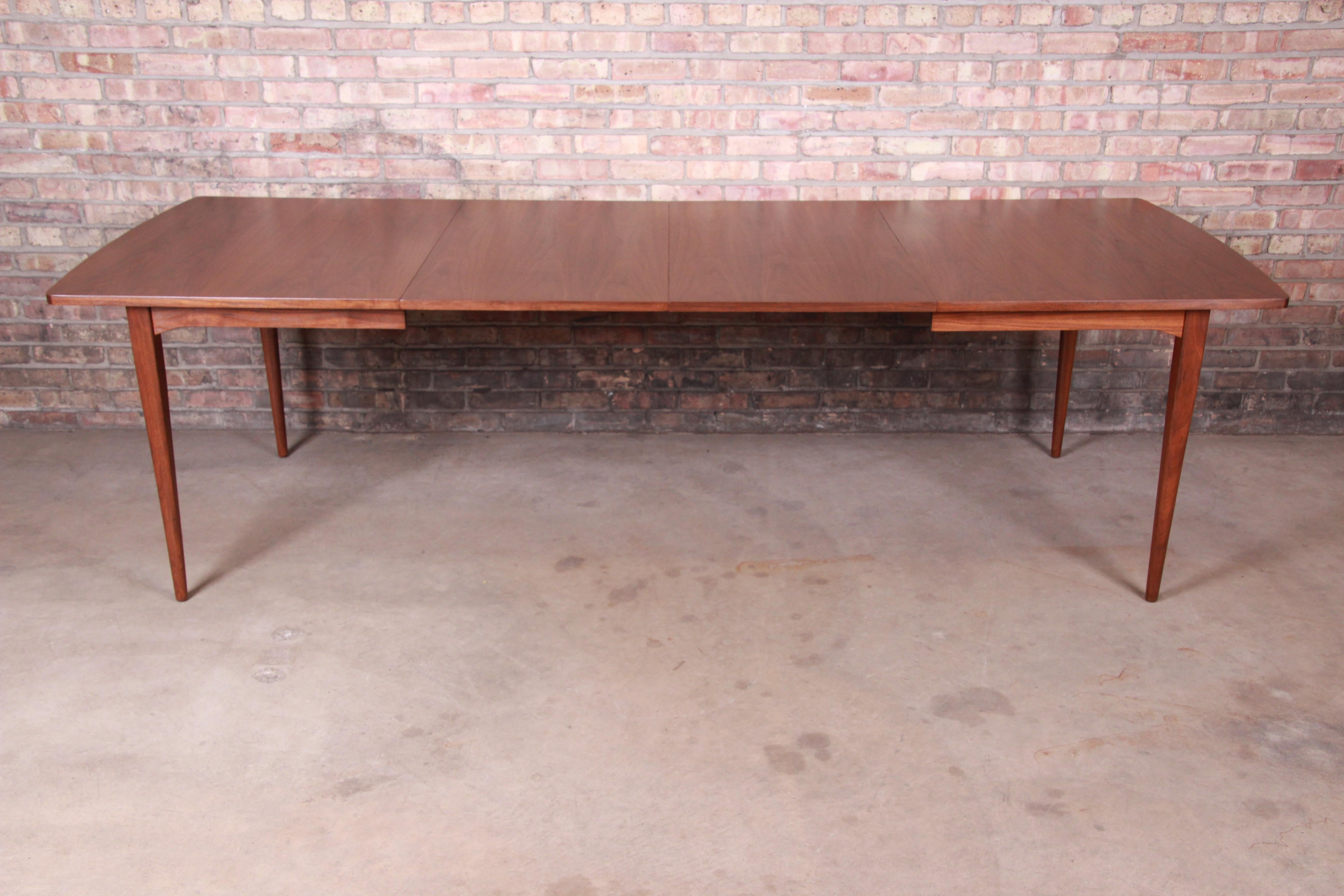 An exceptional Mid-Century Modern walnut extension dining table

By Kipp Stewart for Drexel 