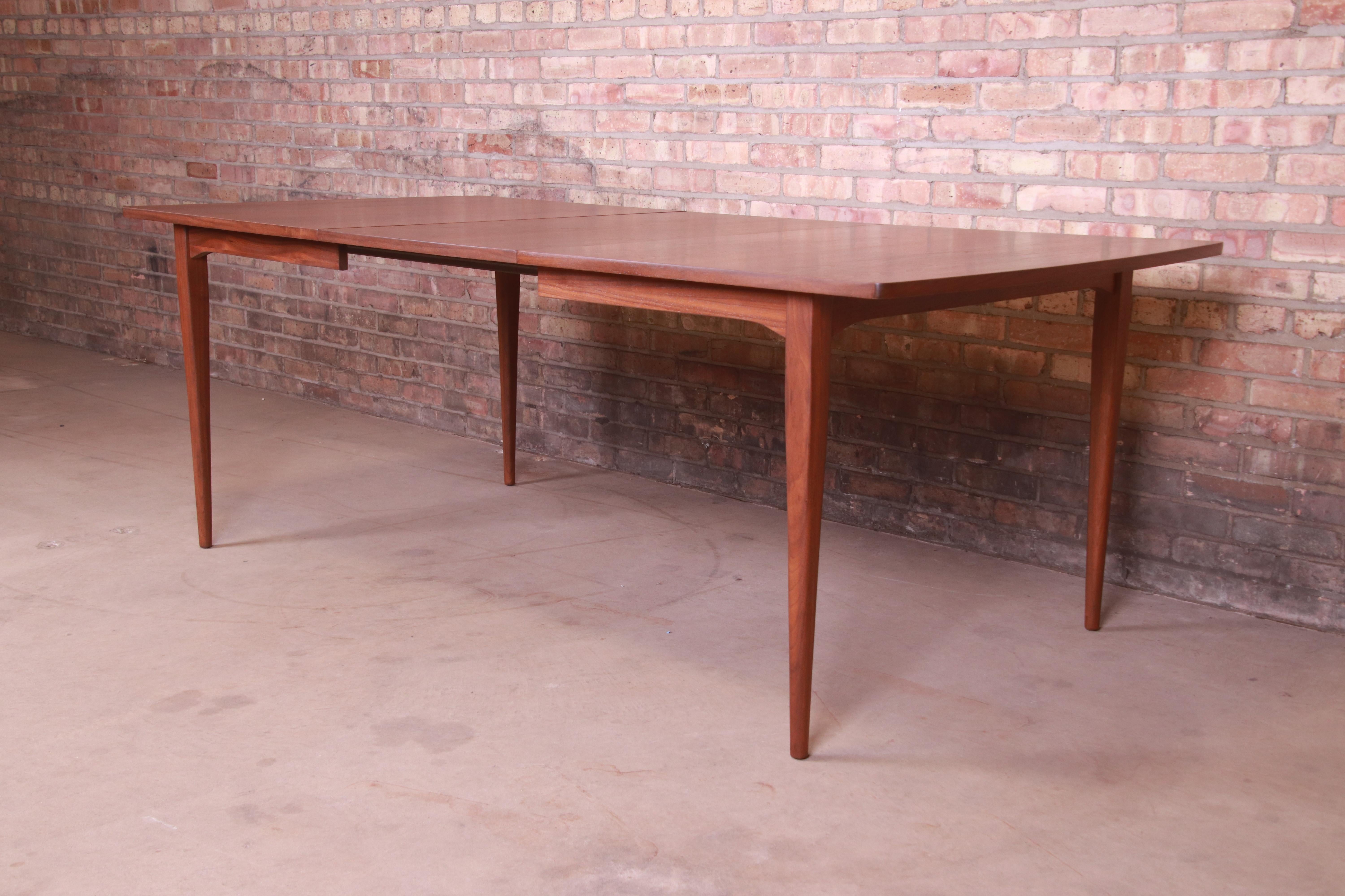 An exceptional Mid-Century Modern walnut extension dining table,

By Kipp Stewart for Drexel 