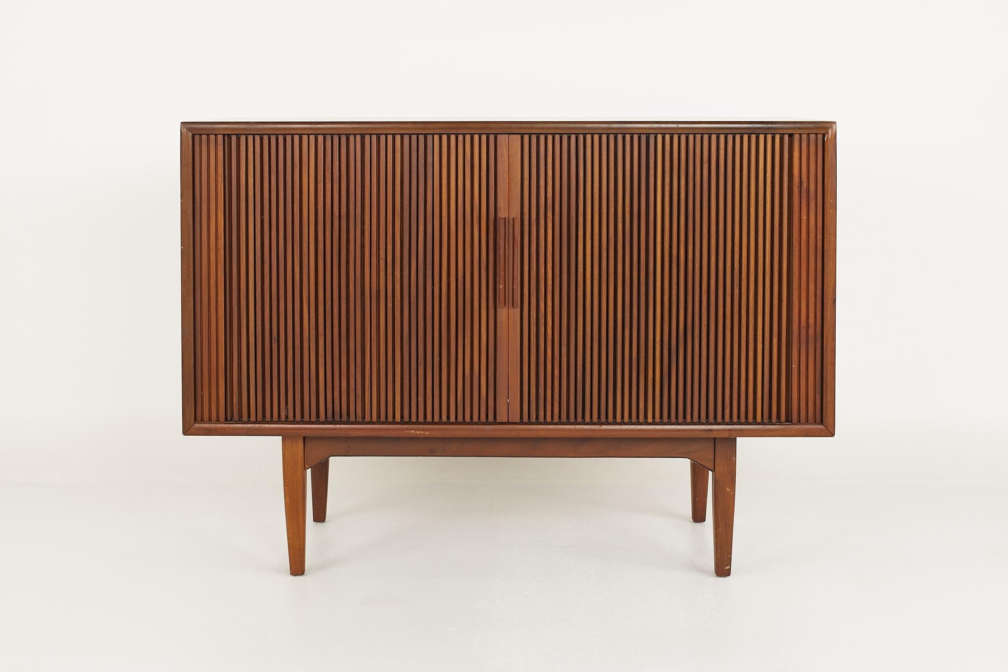Kipp Stewart for Drexel Declarations mid century walnut Tambour door TV media cabinet

This cabinet measures: 43.5 wide x 17.75 deep x 31.25 inches high

?All pieces of furniture can be had in what we call restored vintage condition. That means