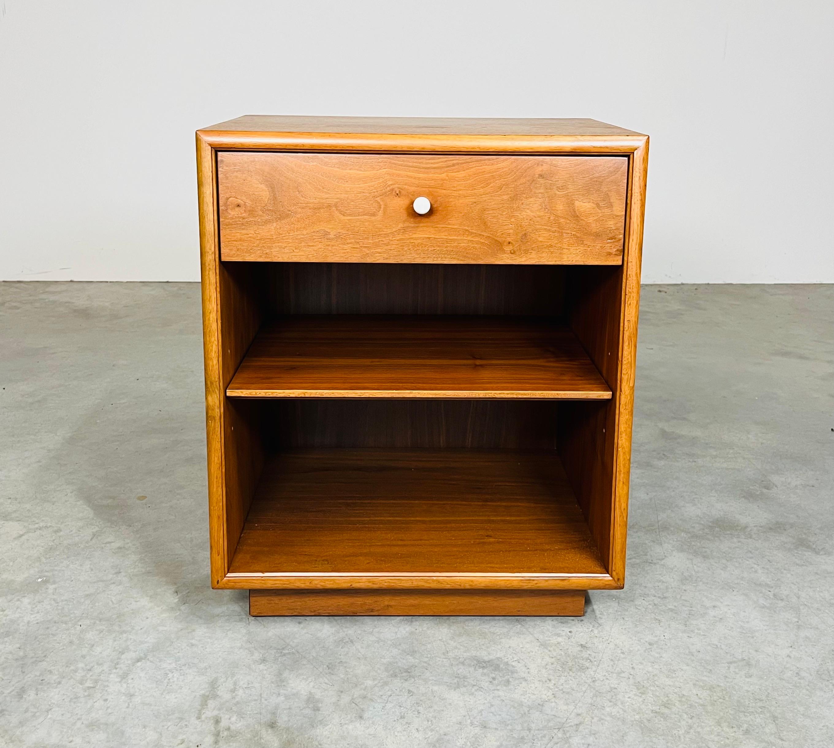 An attractive mid-century nightstand in walnut designed by Kipp Stewart for Drexel’s Declaration line having a playful white porcelain ball drawer pull. 
In excellent condition top to bottom.  
24.5x20x16” HWD