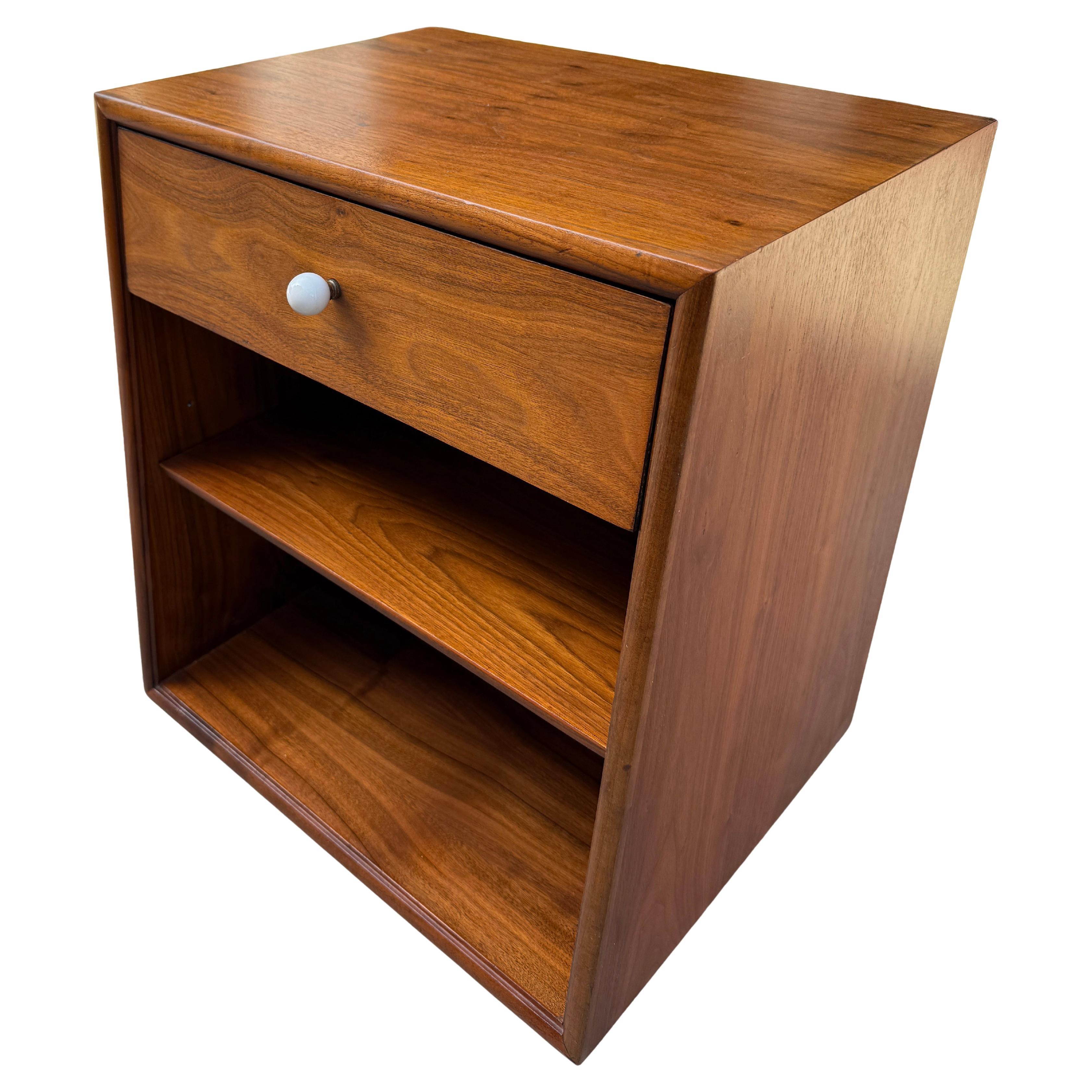 Kipp Stewart for Drexel walnut nightstand or record / LP storage cabinet, circa 1962. Sleek and beautiful by Kipp Stewart for Drexel's Declaration line. Excellent original condition with brass and signature porcelain hardware and adjustable inner