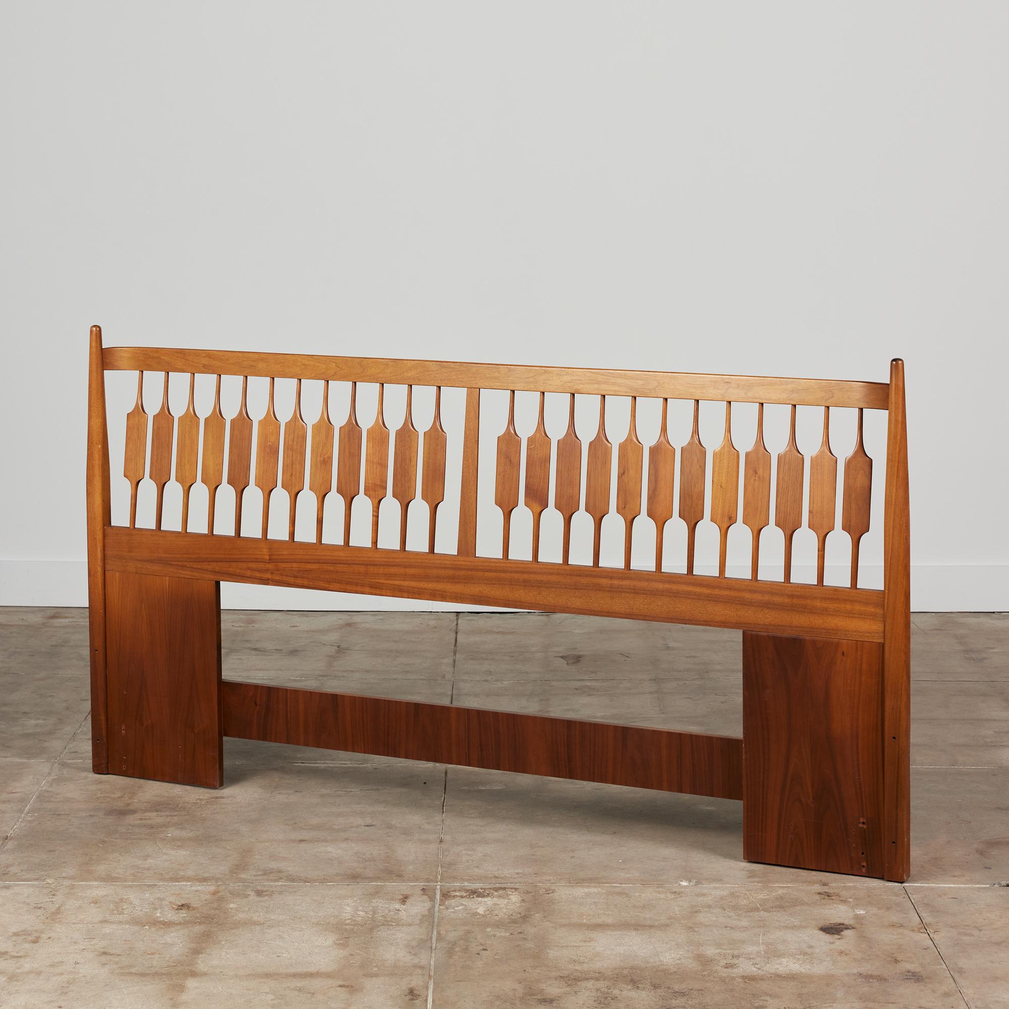 Walnut headboard by Kipp Stewart, c.1960s for Drexel Declaration. This piece is made from solid walnut and features a spindle detail with rectangular accent. There is a slight curve to the back of the headboard.

Dimensions
78