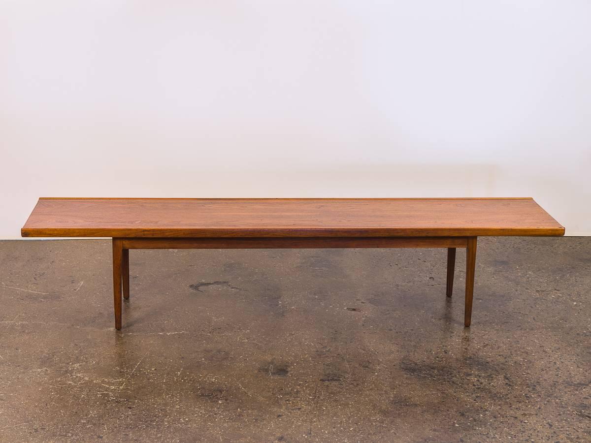 Gleaming, 1960s Kipp Stewart walnut bench for Drexel. This extra long bench stretches an admirable 75 inches long with a subtle lip. Our example owns a very striking wood grain that is lovely to admire. In excellent vintage condition, with minimal