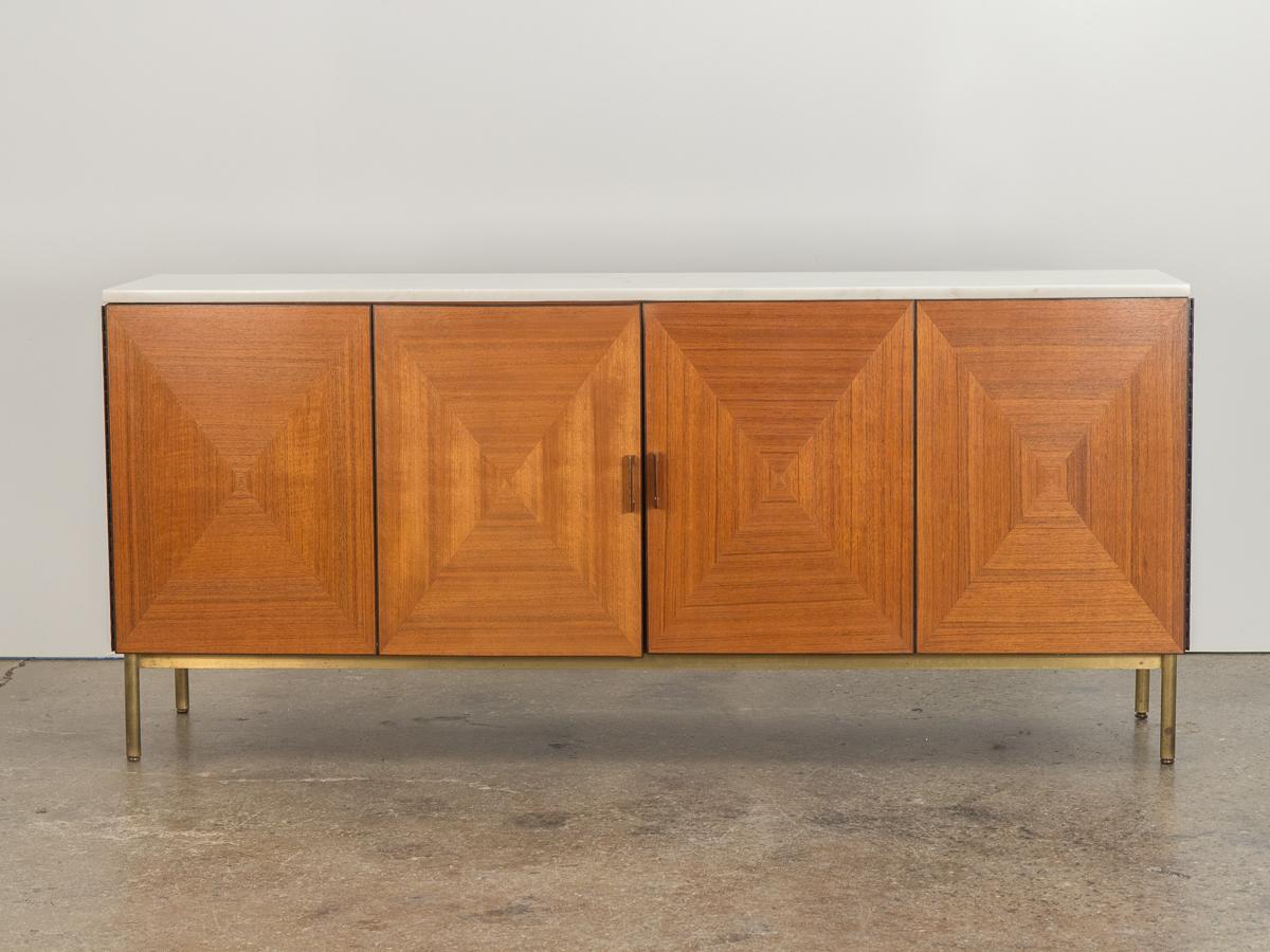 Seldom seen marble and walnut cabinet designed by Kipp Stewart for Calvin Directional. The cabinet is topped with a gorgeous white marble top that is very clean and high quality with minimal veins throughout. Eye-catching walnut marquetry at cabinet