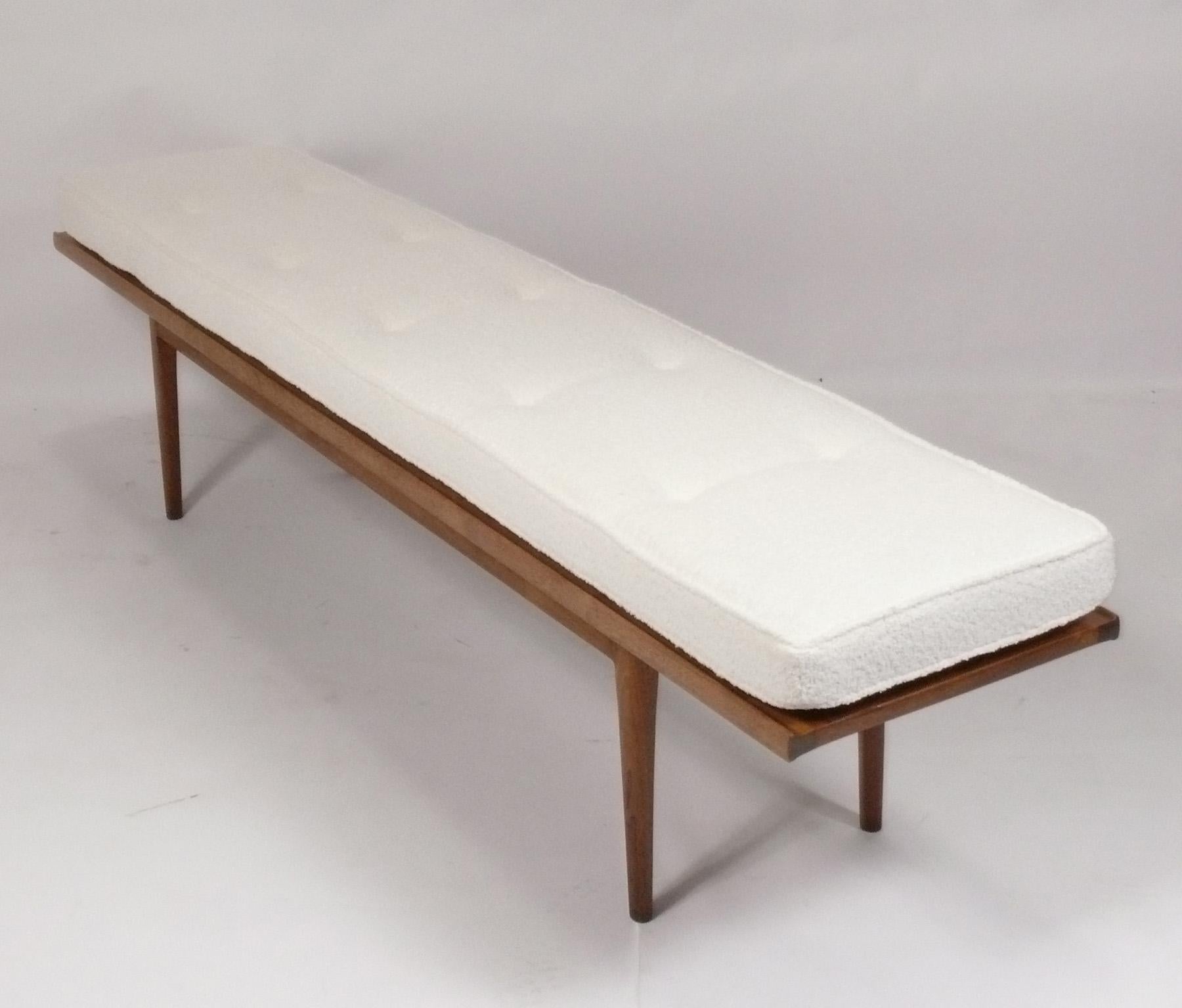 Clean Lined Mid Century Bench, designed by Kipp Stewart for Drexel, signed, American, circa 1960s. The walnut frame has been cleaned and oiled and a new cushion constructed with new foam and ivory color boucle fabric. 