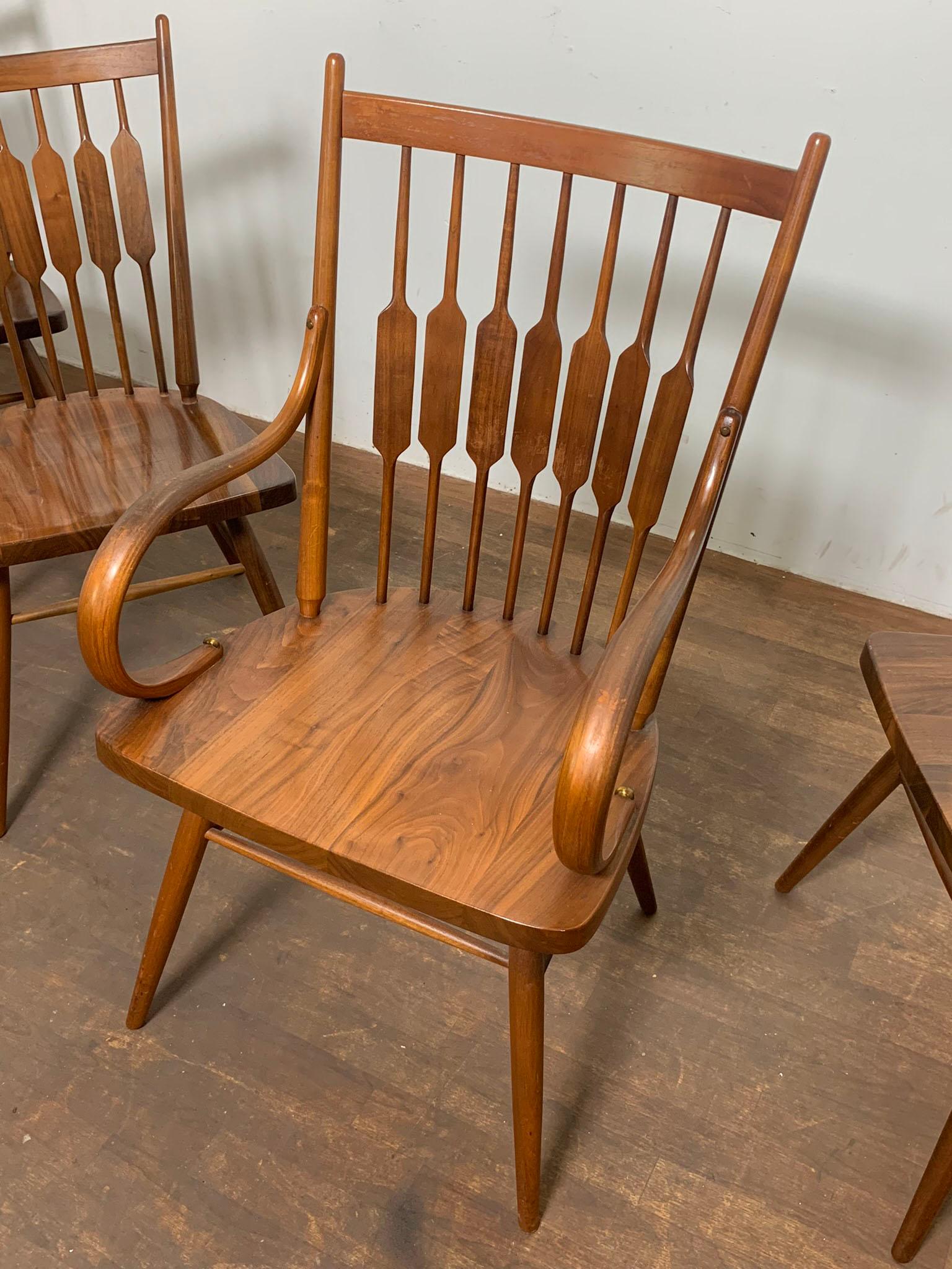 Set of five walnut dining chairs designed by Stewart MacDougall & Kipp Stewart for the Drexel Centennial line, circa 1960s.

Arm chairs measure 21