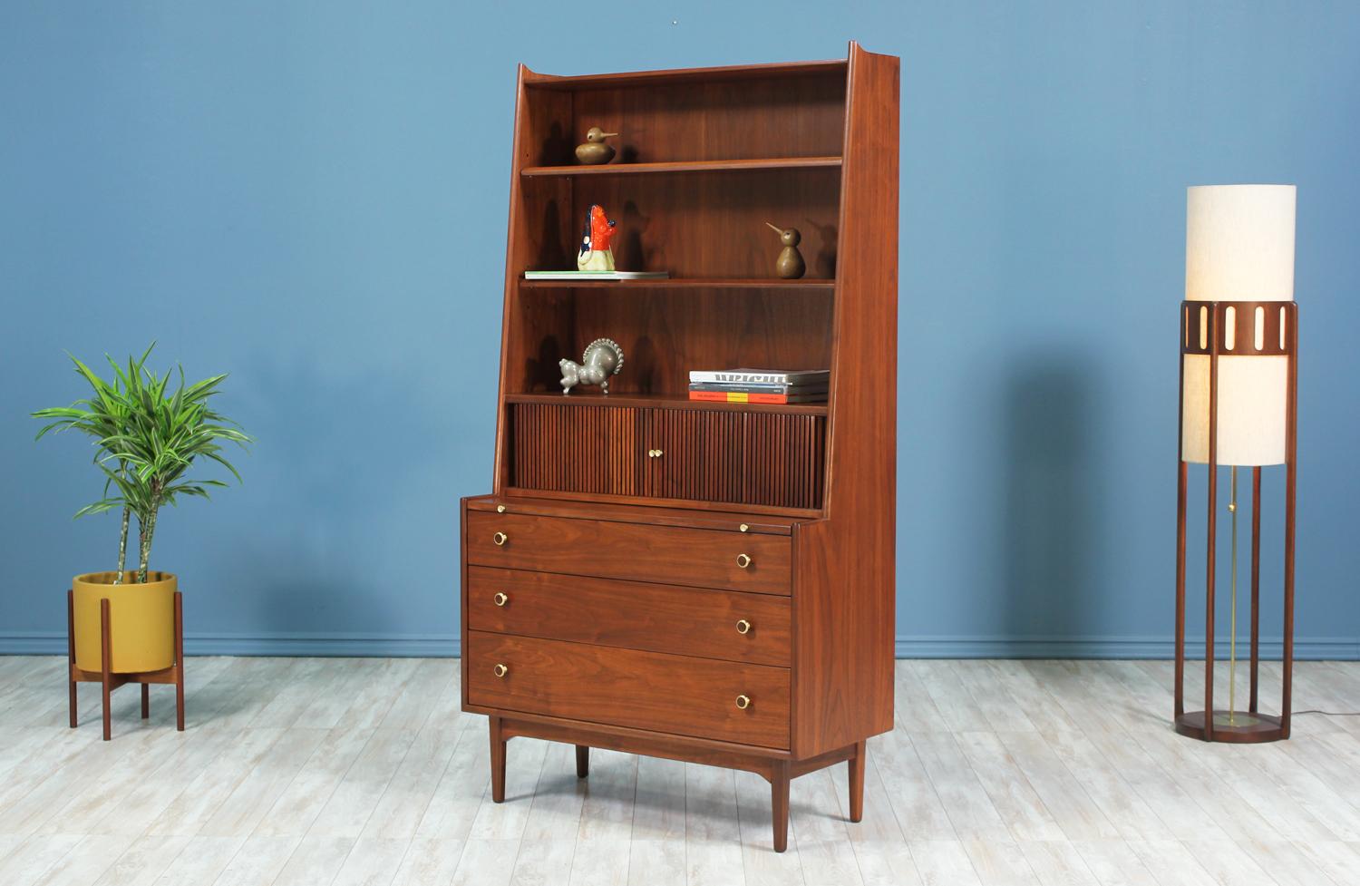 Tall Bookshelf with desk designed by Kipp Stewart & Stewart MacDougall for Drexel’s iconic Declaration collection and manufactured in the United States circa 1960’s. This multifunctional piece features a beautiful and rich walnut wood frame with