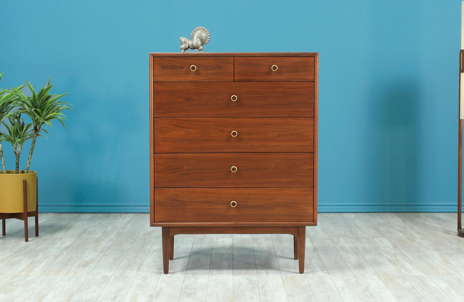 Stunning chest of drawers designed by Kipp Stewart & Stewart MacDougall for Drexels Declaration line in the United States circa 1960’s. The chest features six walnut wood dovetailed drawers adorned by their original brass pulls with walnut inlay.