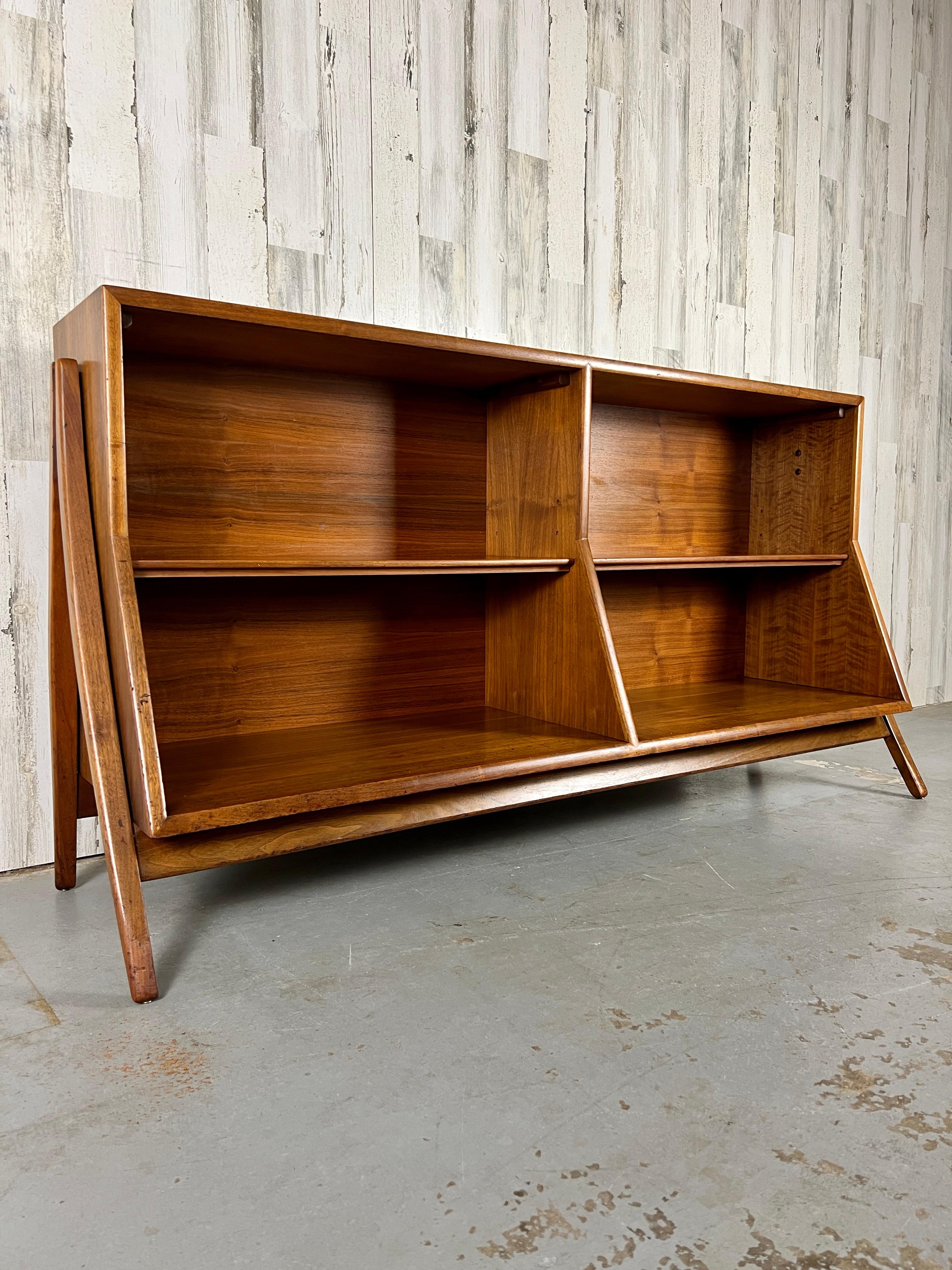 Sculptural walnut exterior legs with beveled case and shelves.
Designed by
Kipp Stewart & Stewart MacDougall 