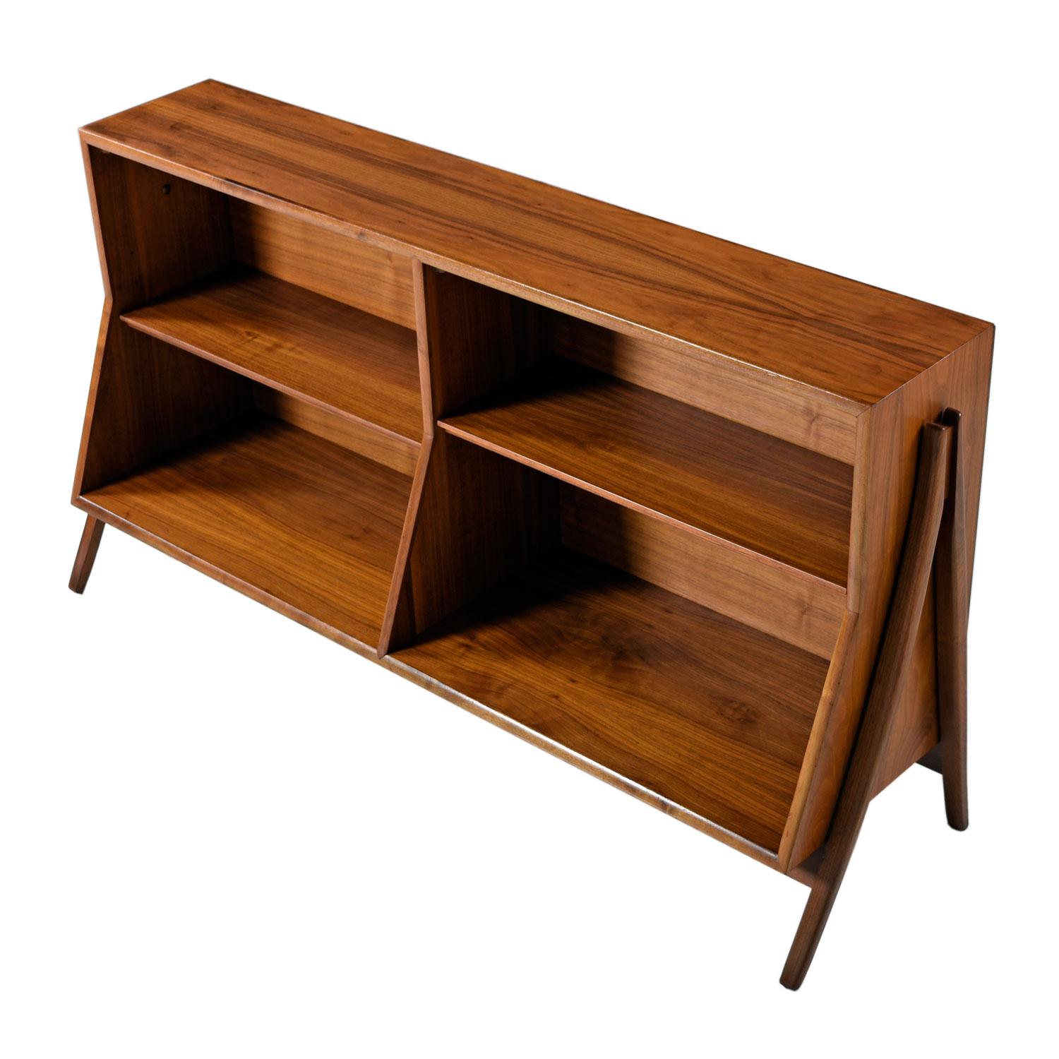 Super stylish Mid-Century Modern bookcase. Designed by Kipp Stewart and Stewart MacDougall for Drexel. Part of their famed, “Declaration” collection. A rare piece that hardly surfaces. Check out the ever graceful, swooping legs on the side. Fixed to
