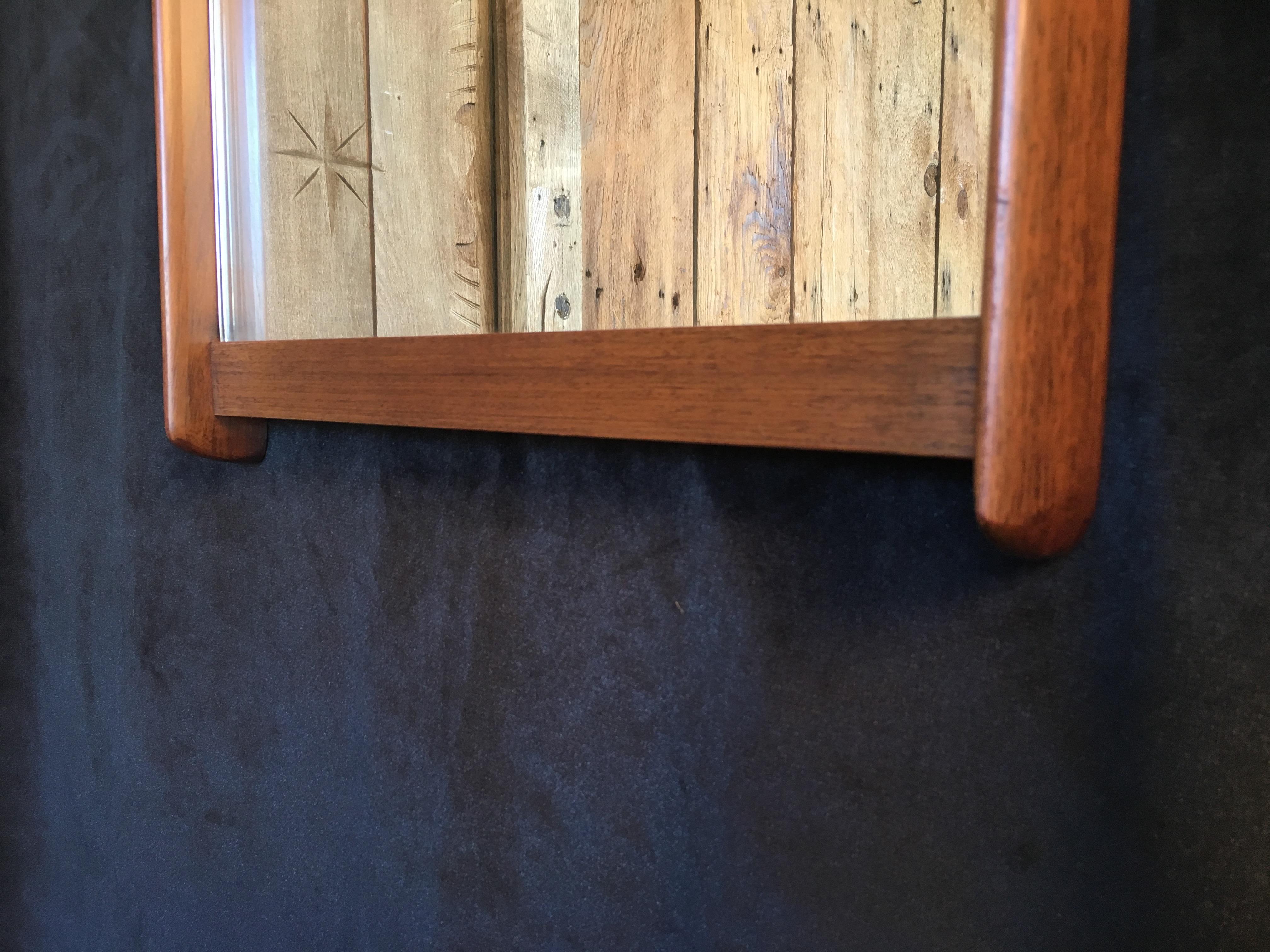 Nice size mirror flanked on each side and the bottom with solid walnut.