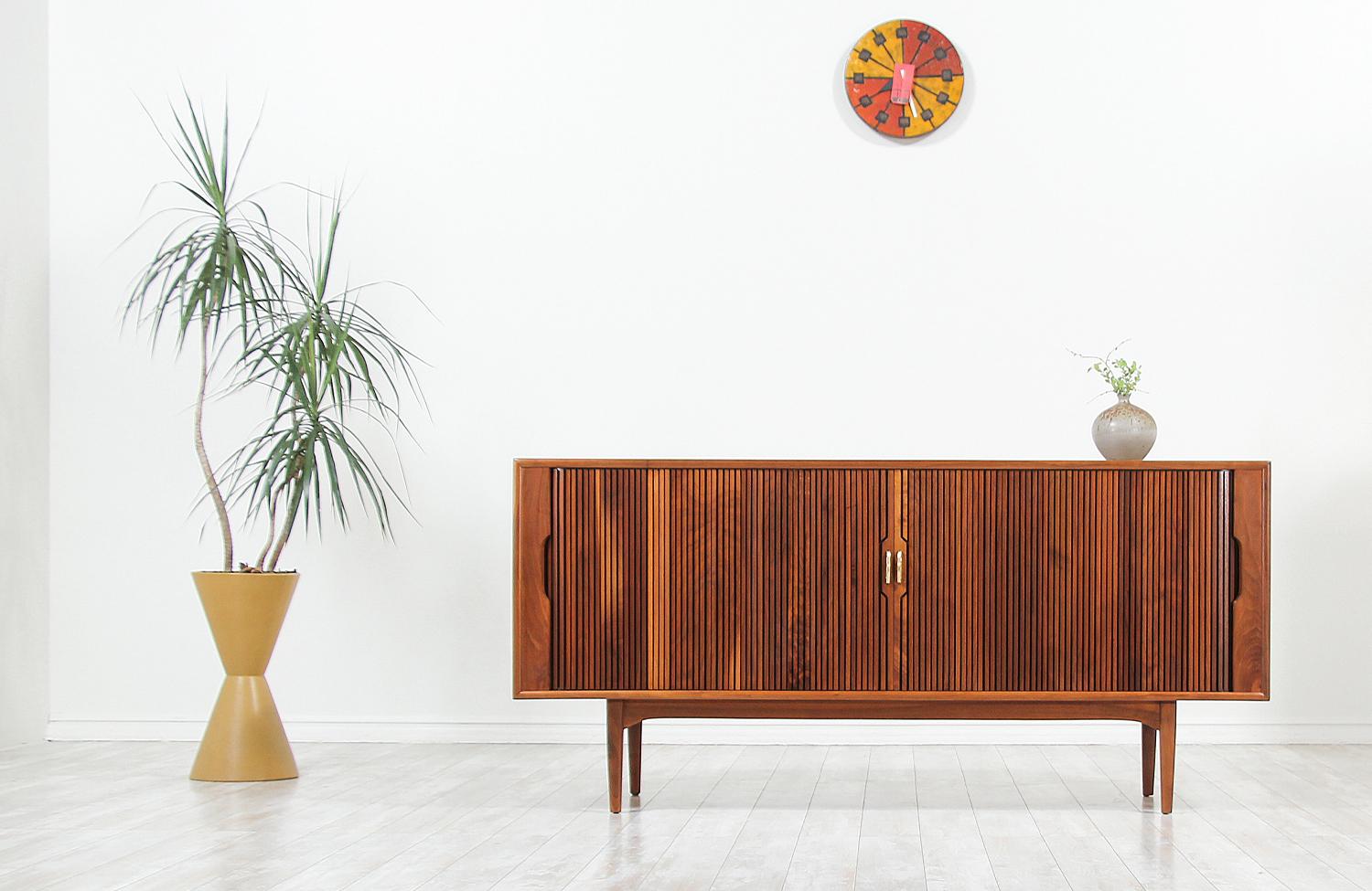 Mid-Century Modern tambour door credenza designed by Kipp Stewart & Stewart MacDougall for Drexel’s “Declaration” line in the United States, circa 1960s. This Fine credenza features a walnut wood frame with a beautiful grain detail and smooth