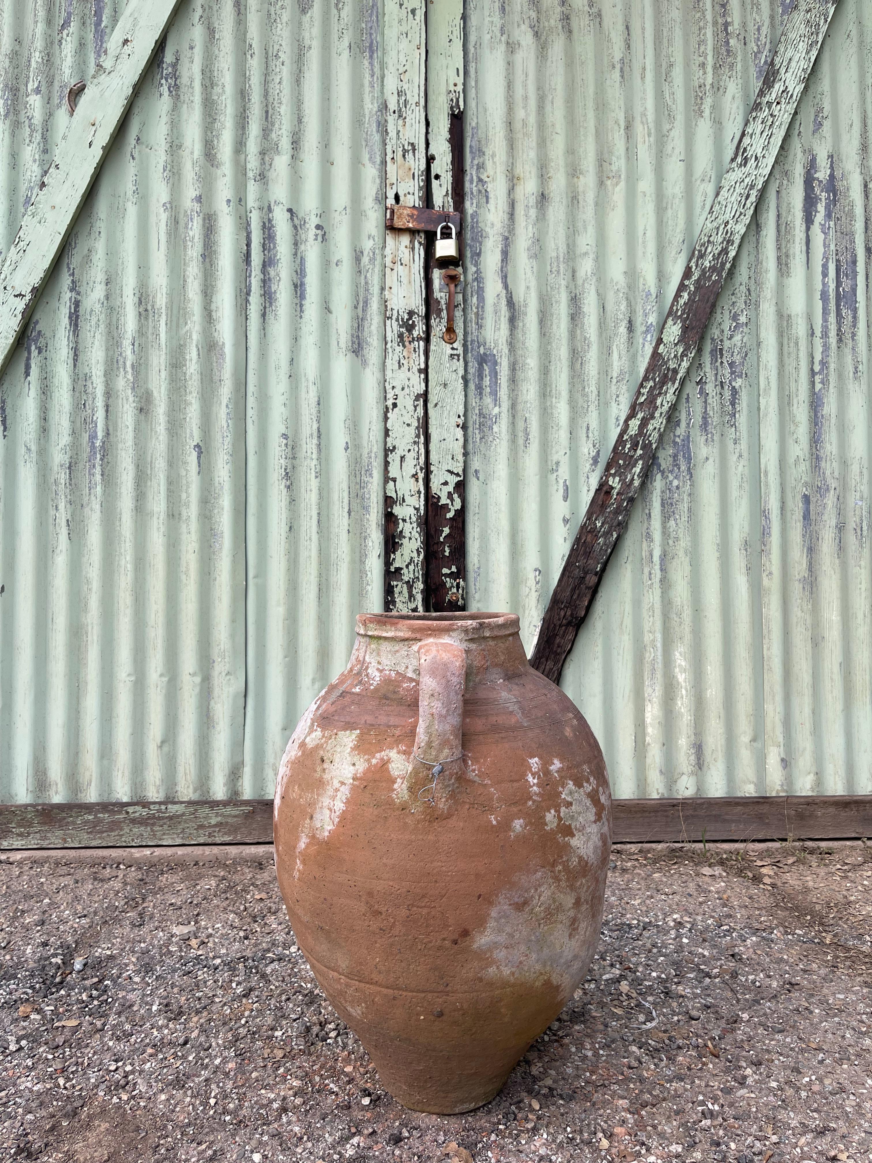 This medium-sized limewashed Turkish pot was used to gather, store, and preserve food, water, or wine in the Levant. Lime-washing is a technique that has been used for centuries by Anatolian ceramicists to refresh, seal, and protect the surface of a