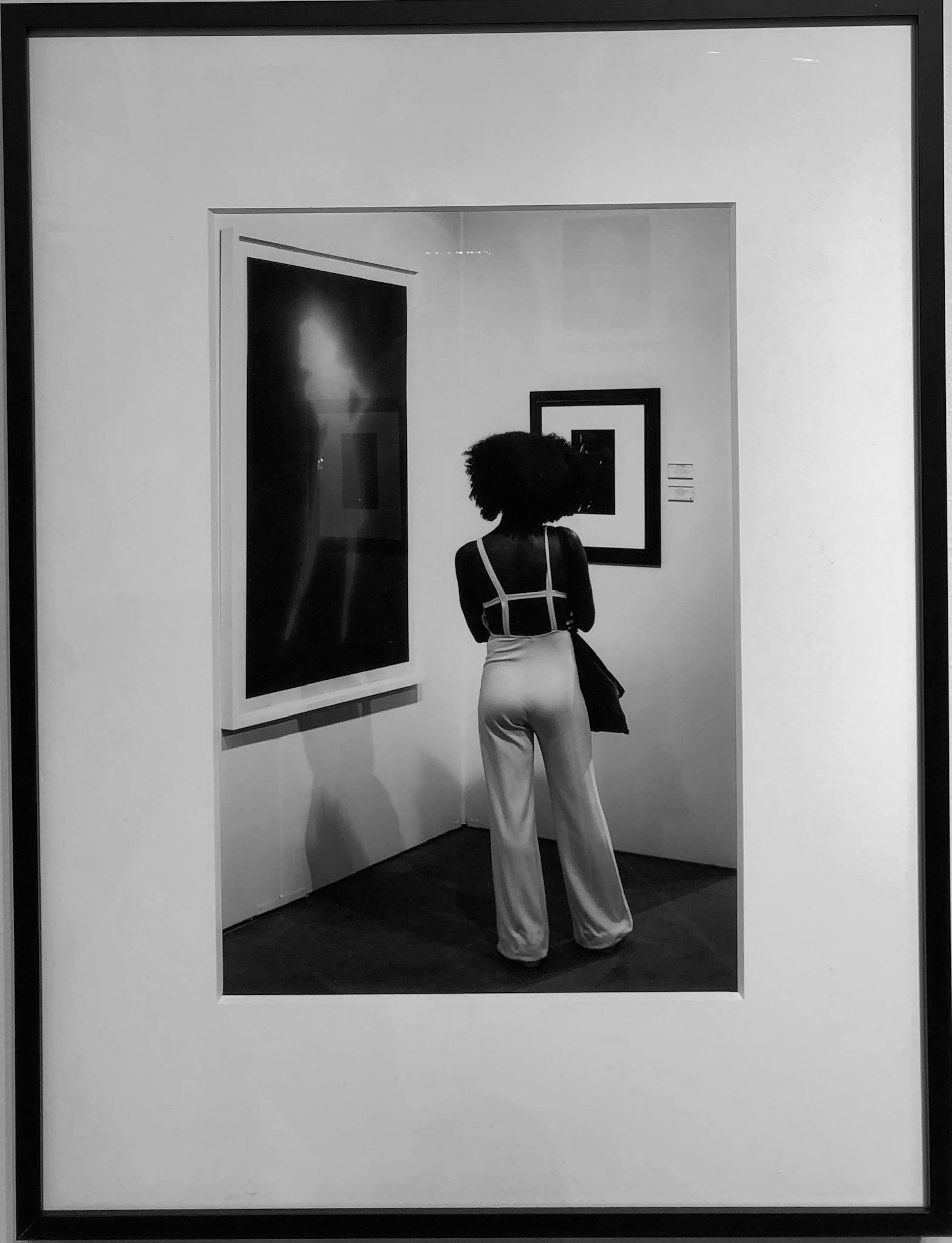Woman and Art, Chicago, Framed Black and White Photo of Woman Looking at Art - Photograph by Kirill Polevoy