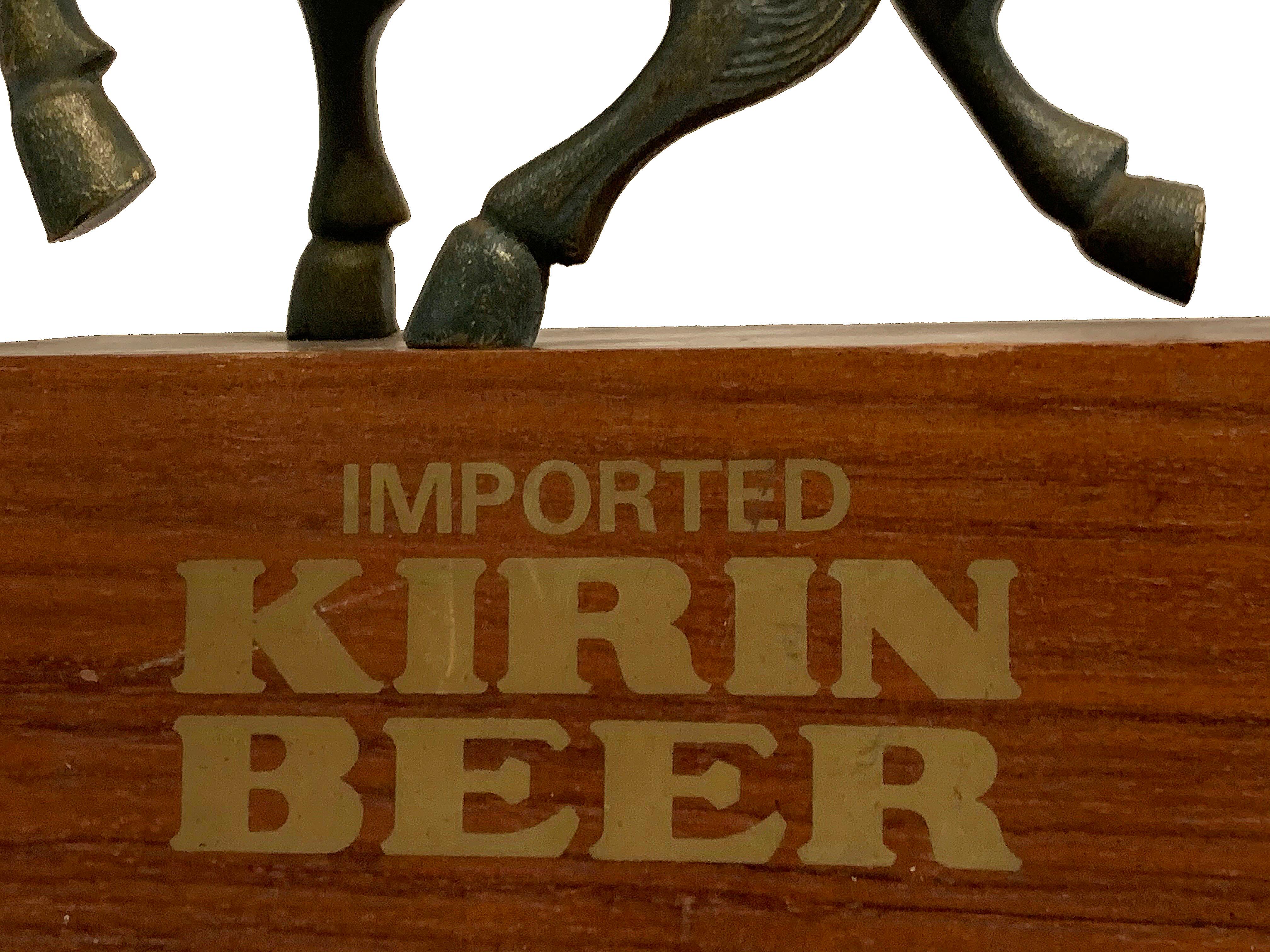 Metal on wood Imported Kirin beer sculpture. Base reads 
