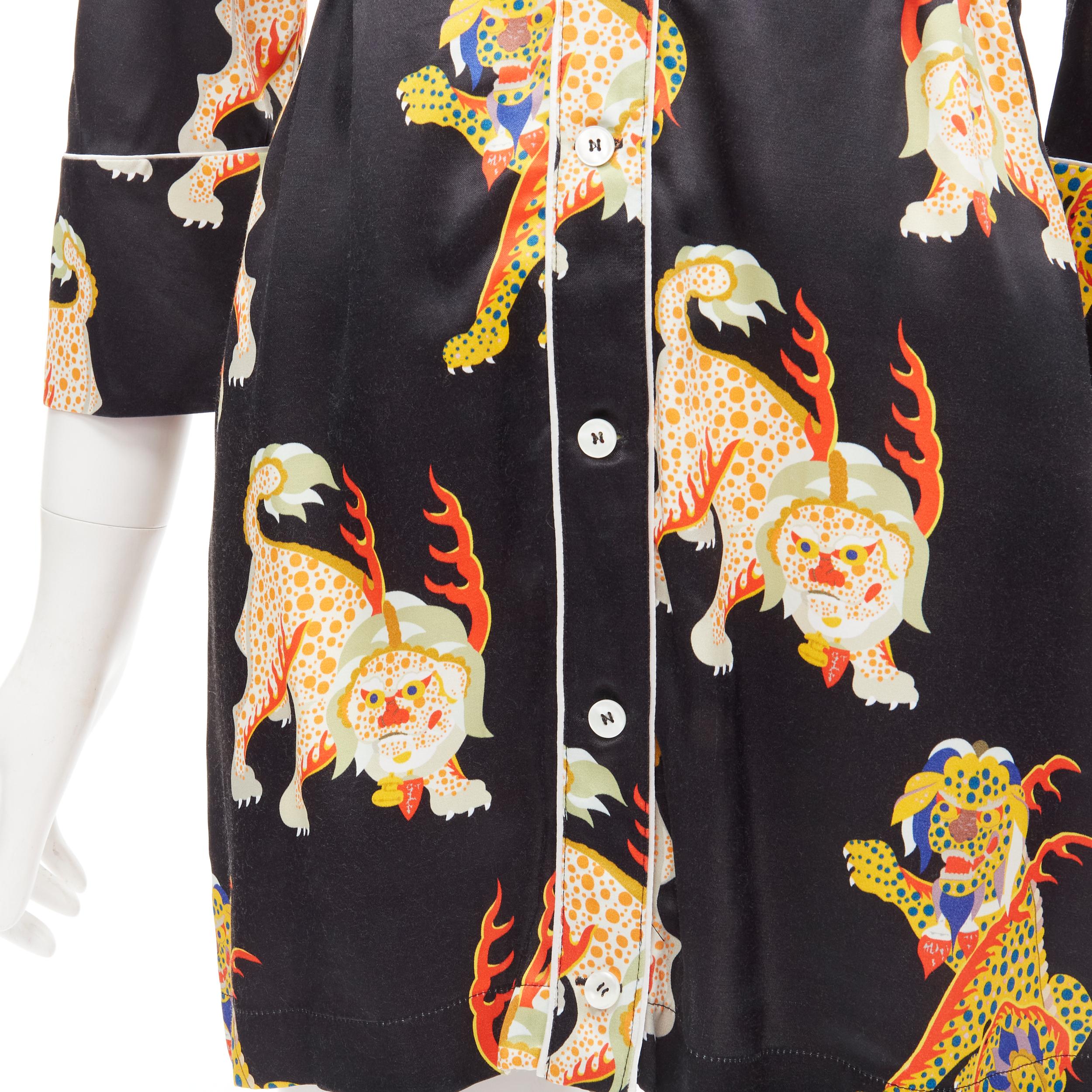 KIRIN PEGGY GOU black oriental lion short sleeve drawstring long length shirt S 
Reference: ANWU/A00399 
Brand: Kirin 
Designer: Peggy Gou 
Color: Black 
Pattern: Lion 
Closure: Button 
Extra Detail: Drawstring at waist. 

CONDITION: 
Condition: