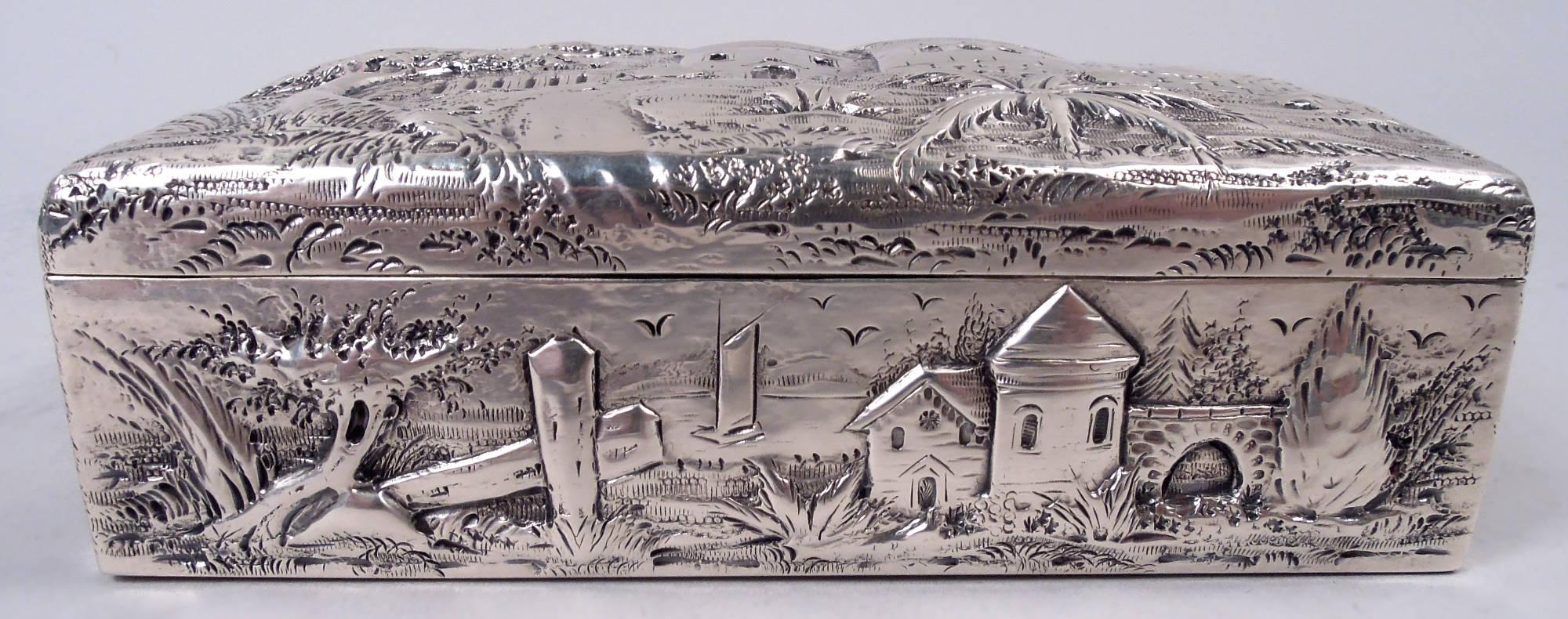 Edwardian sterling silver box. Made by S. Kirk & Son Inc. in Baltimore. Rectangular with cover. Picturesque architecture with turrets, manors, and bridges in bosky landscapes. Pastoral fantasy scenes in low relief. Fully marked including maker’s