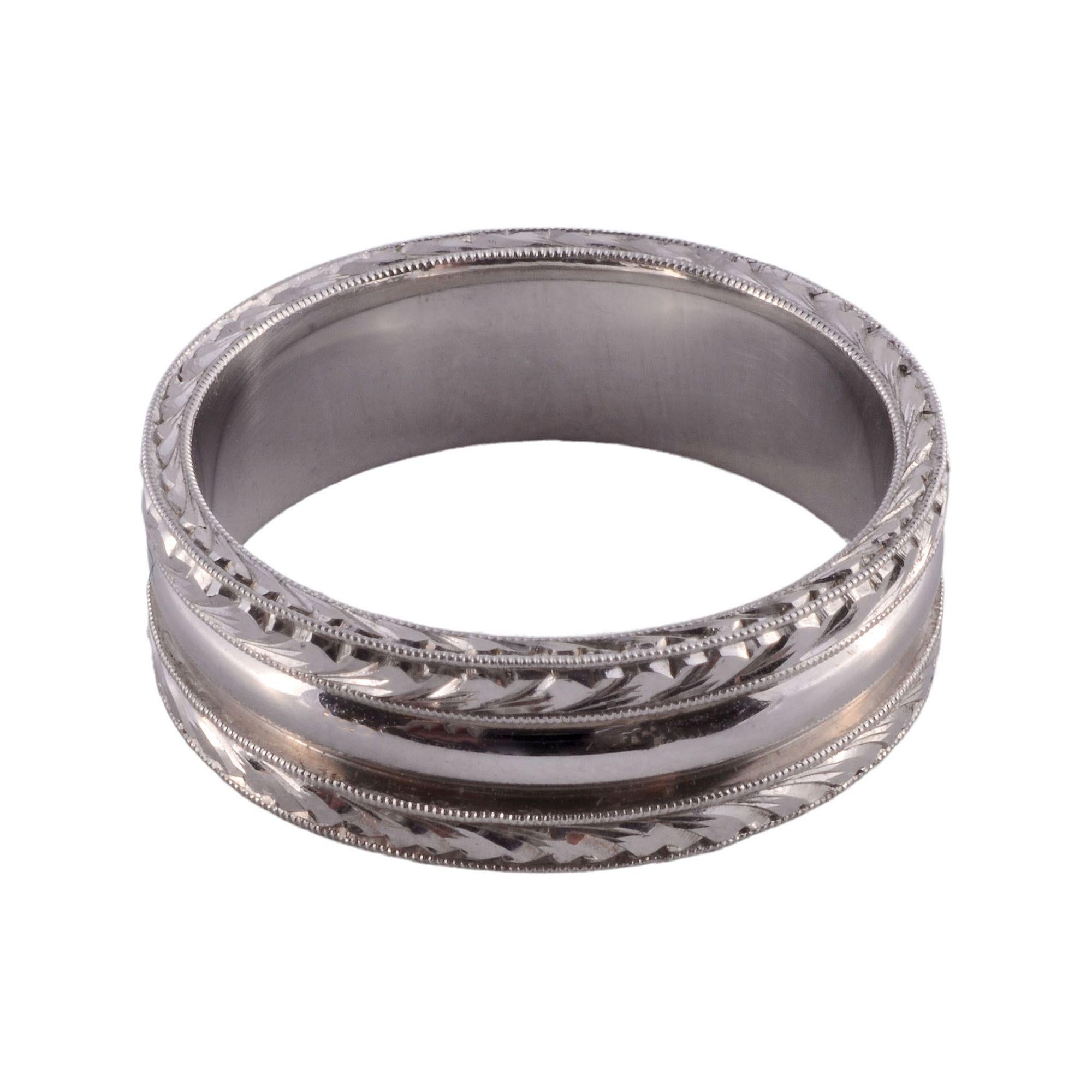 Estate Kirk Kara 18 karat white gold wedding band. This fine wedding band features deep chase work and hand engraving with excellent workmanship. This 18KW wedding band is a size 10. [KIMH 193A P]