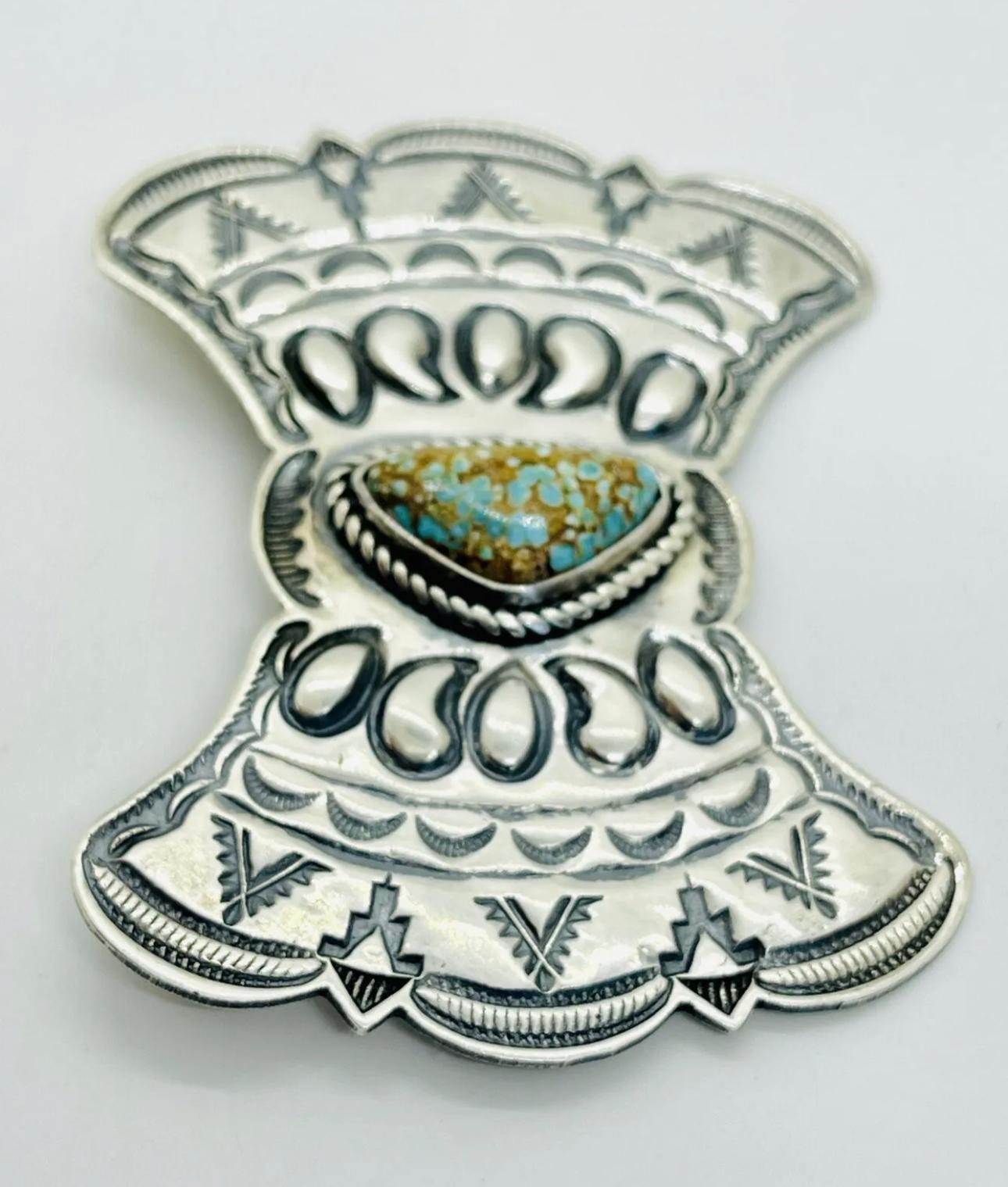 Vintage Signed Native American Navajo Sterling Silver Stampwork Brooch w/ Incredible Fine Ultra High Gem Grade Water Web “Birdseye” Matrix Turquoise Cabochon Brooch by

KIRK SMITH (1957, New Mexico - 2012, New Mexico)

2.75” x 2”

23.3 g

Excellent