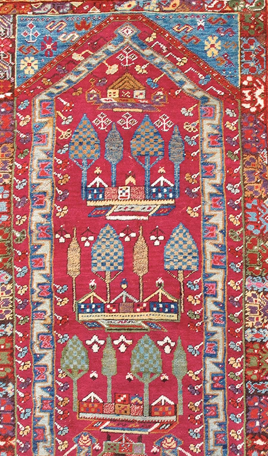 This colorful prayer rug from the area of Kirshehir in northern Anatolia paints a repeat image of a courtyard planted with cypress trees. A prayer niche—or mihrab—is outlined in blue with geometric zig-zags, most probably an abstraction of a