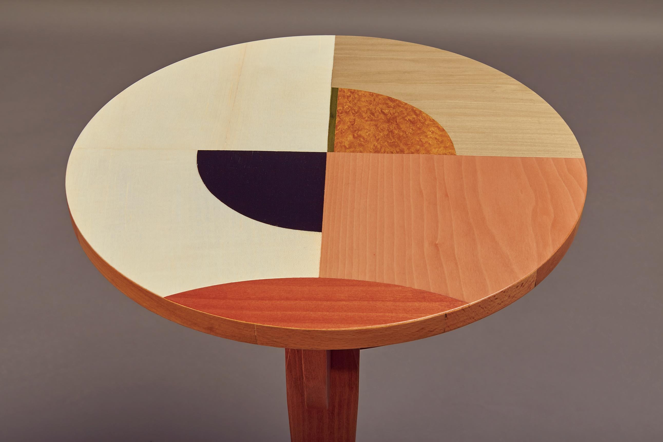 Side table in dyed pink ash with colored top inlay from different woods embellished with an aluminum ring.

Suprematism (Russian: ?????????´??) is an art movement focused on basic geometric forms, such as circles, squares, lines, and rectangles,