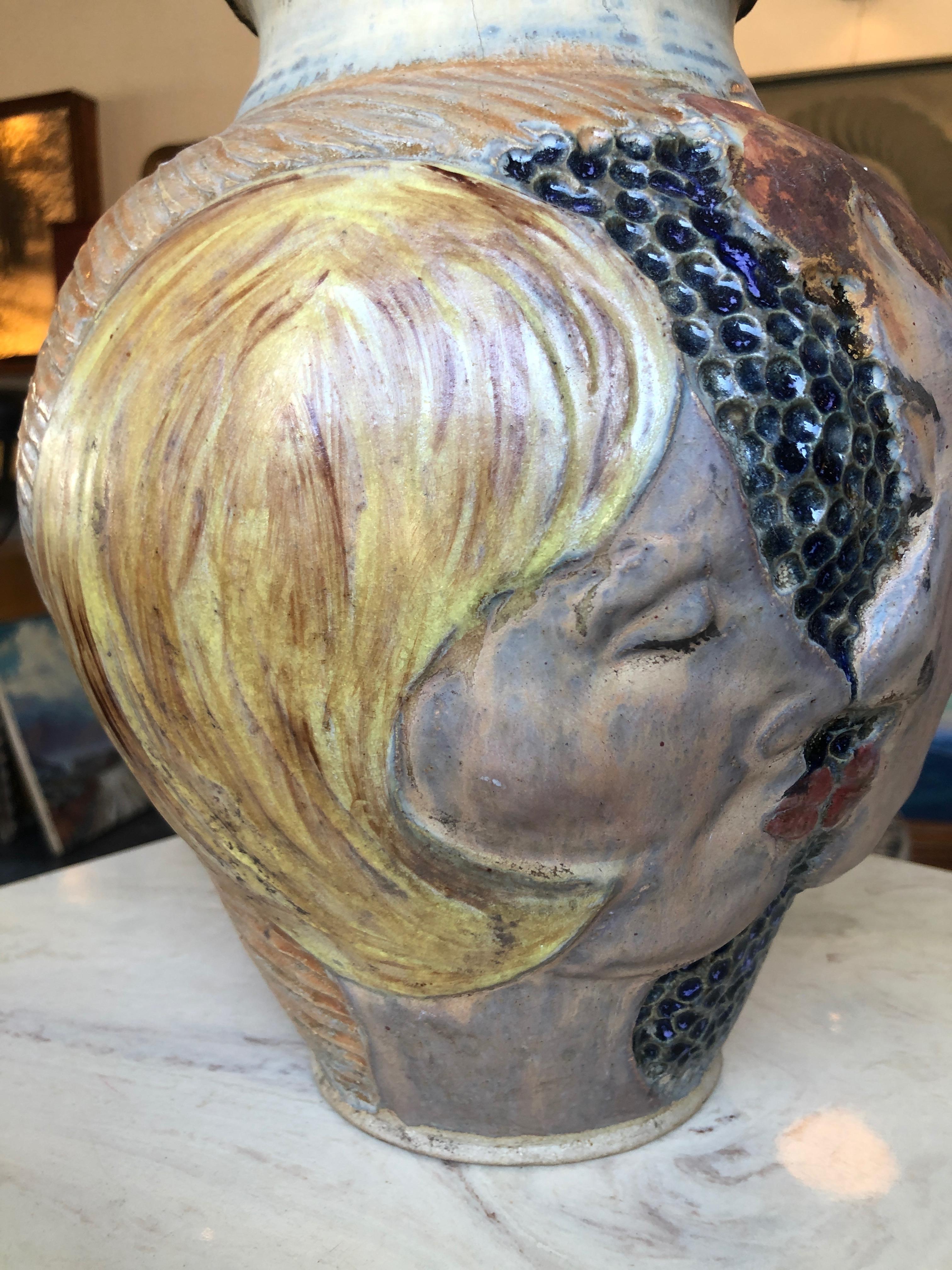 This is a fun display of love and affection in the form of an art pottery vase by Alison McCauley. Signed 