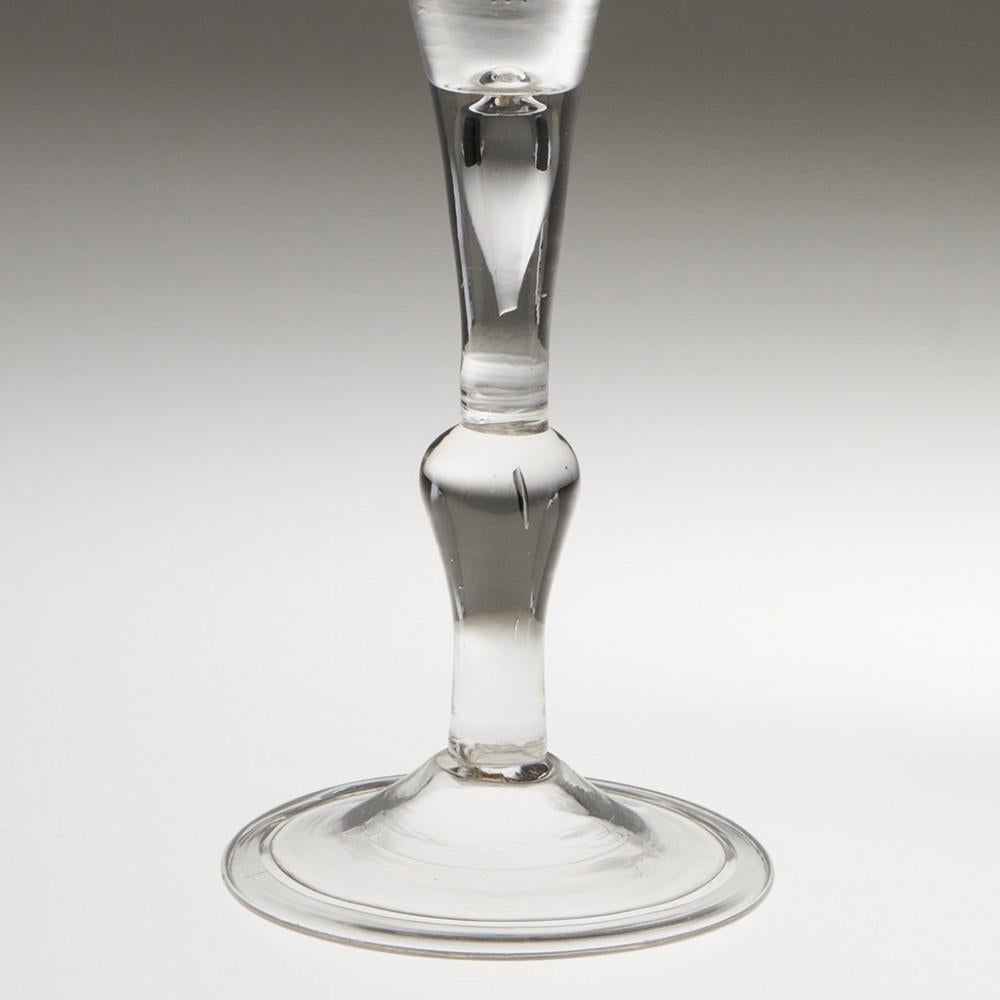 Heading : Kit-Cat Georgian balustroid wine glass
Period : George II - c1745
Origin : England
Colour : Clear with good grey hue
Bowl : Drawn trumpet
Stem : Kit-cat type - plain section (with air tear) above inverted baluster.
Foot : Folded